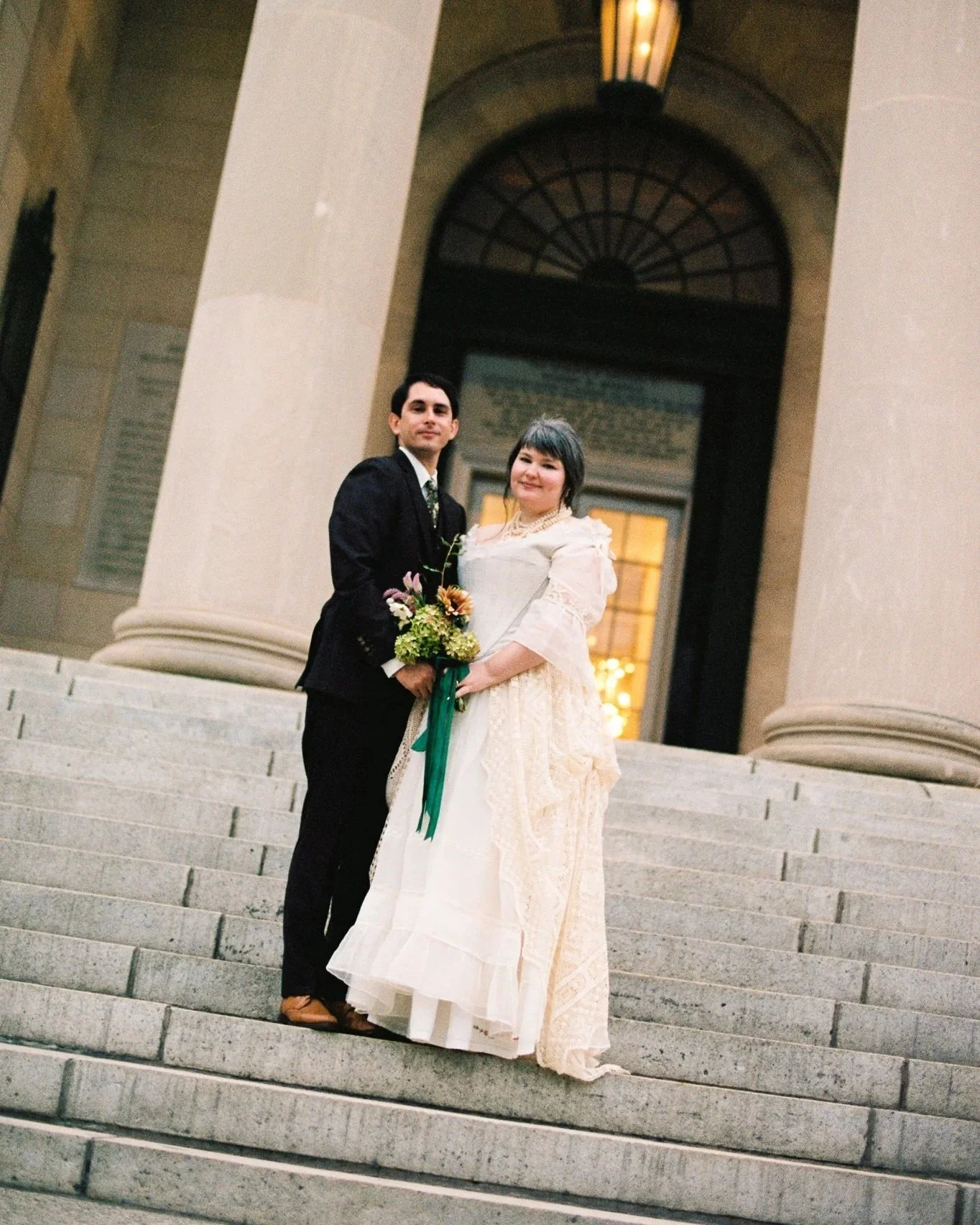 bride and groom on the steps of the Baltimore museum of art