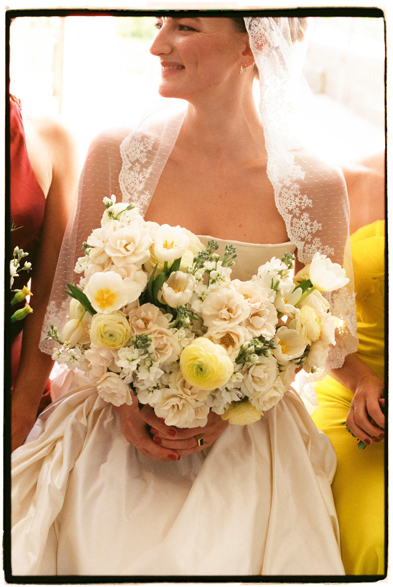 sun filled portrait of bride with yellow and white flowers