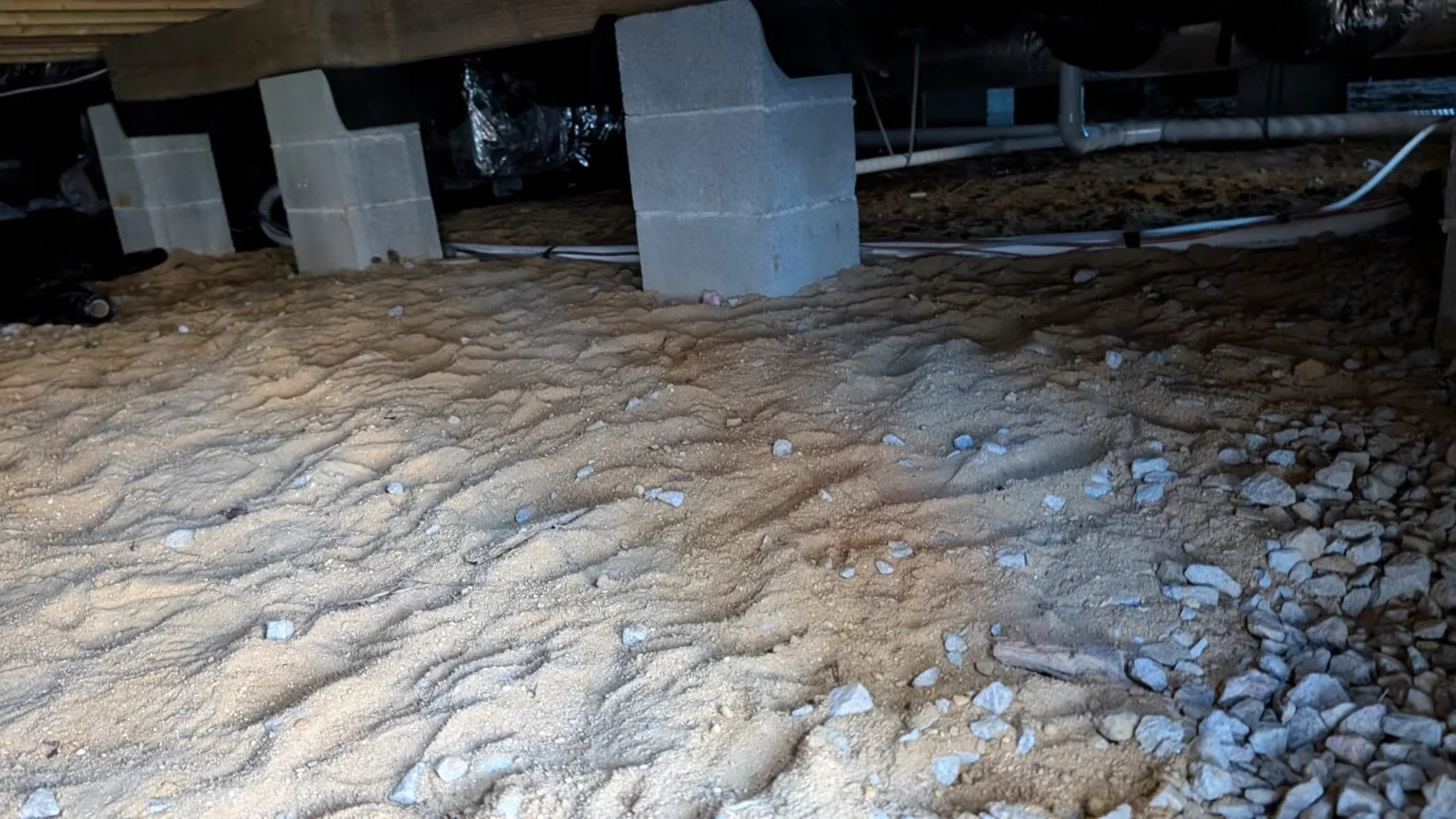 The crawlspace  below a home.