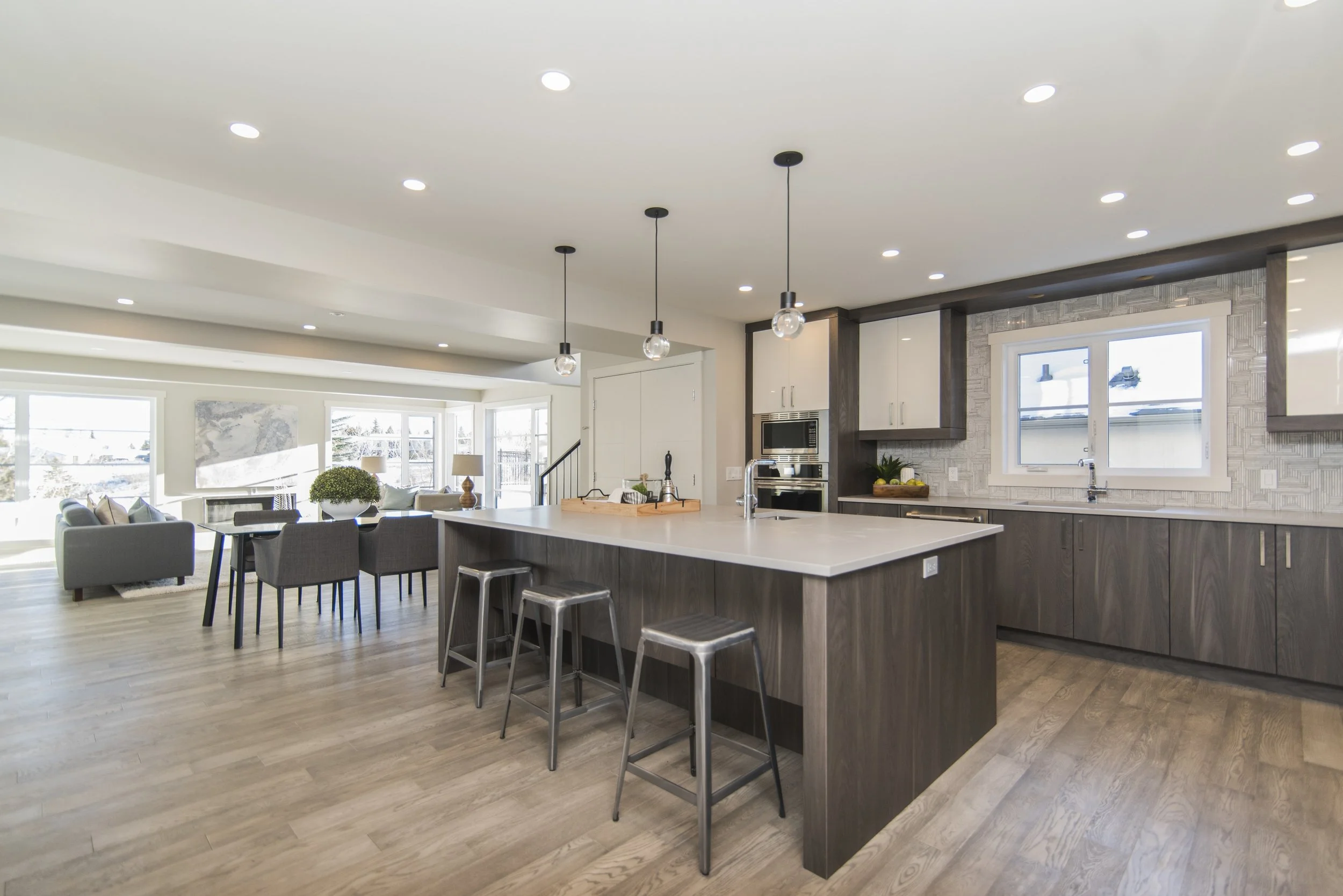 A modern open floorplan home showing the kitchen, dining room and living room.