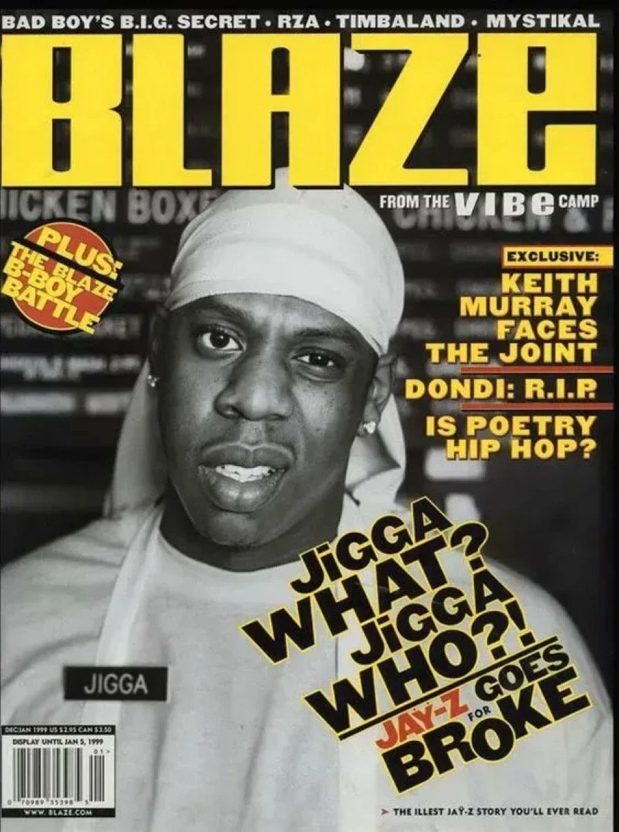 Cover of Blaze magazine featuring a black-and-white photo of rapper Jiggah wearing a white headwrap, with bold yellow and black text surrounding the image, including headlines about Jay-Z and other artists.