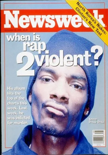 Magazine cover of Newsweek featuring a close-up photo of Snoop Dogg wearing a blue beanie, with bold white and red text asking 'when is rap violent?' and highlighting North Korea's nuclear test and Clinton's new test.