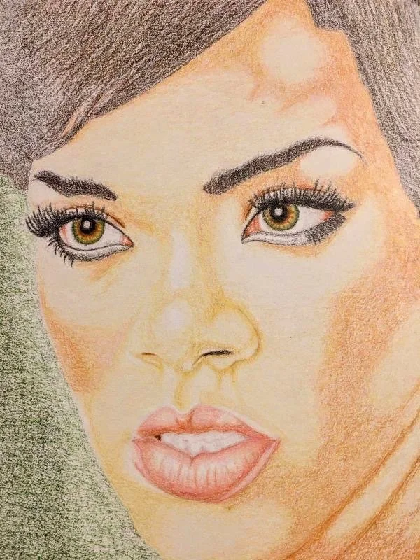 Colored pencil drawing of a woman with brown hair, green eyes, long eyelashes, and pink lips.