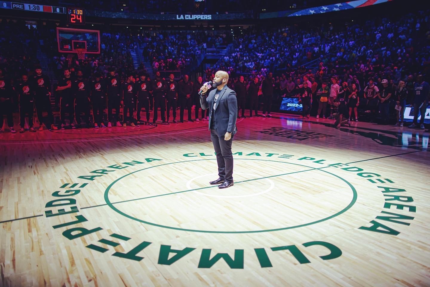 Man singing on basketball court at Climate Pledge Arena