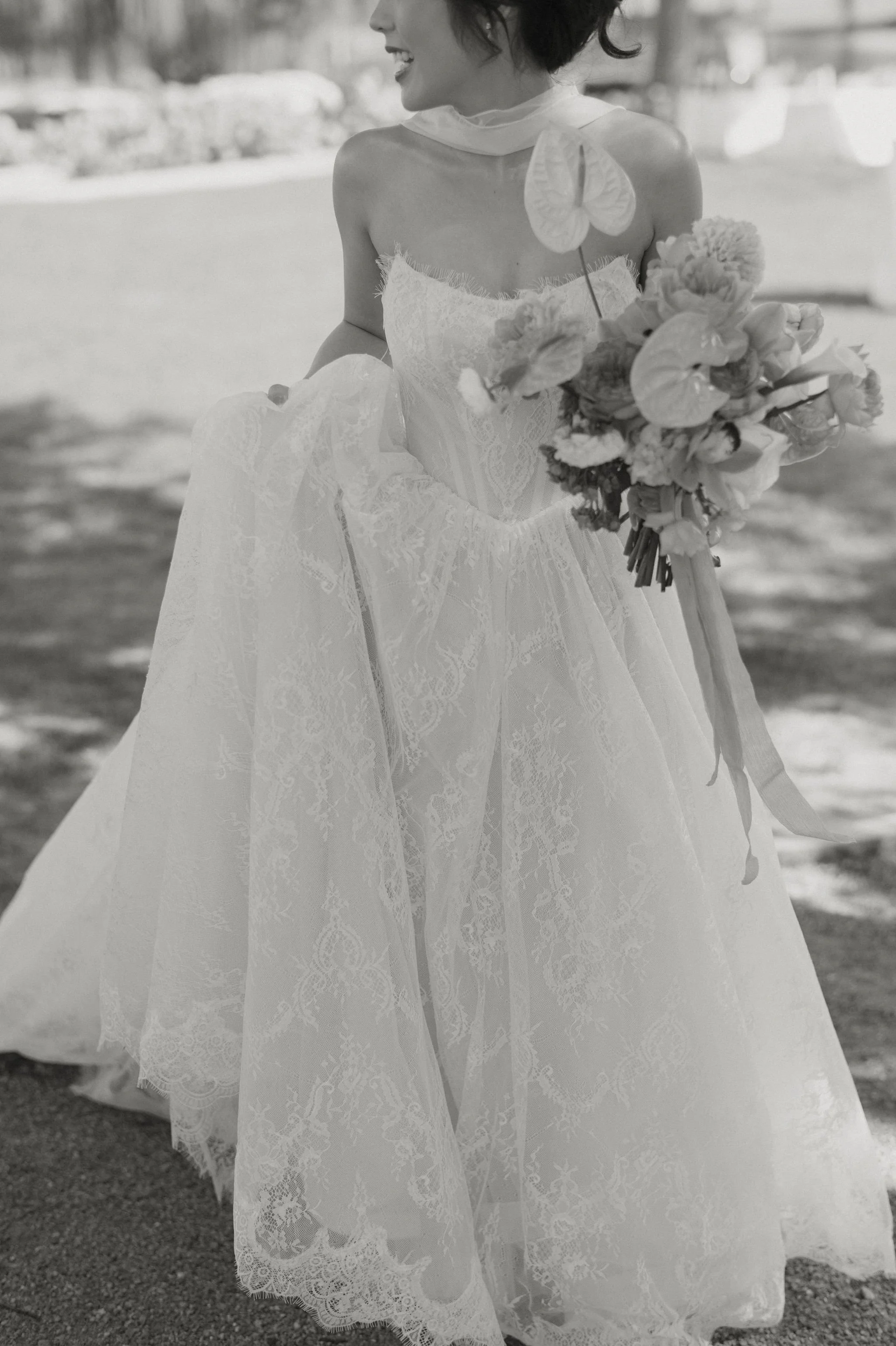 A woman in a wedding dress holding a bouquet of flowers.