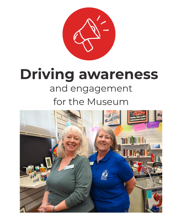 Two women smiling inside a museum gift shop, with books and colorful decorations in the background, promoting driving awareness and engagement for the museum.