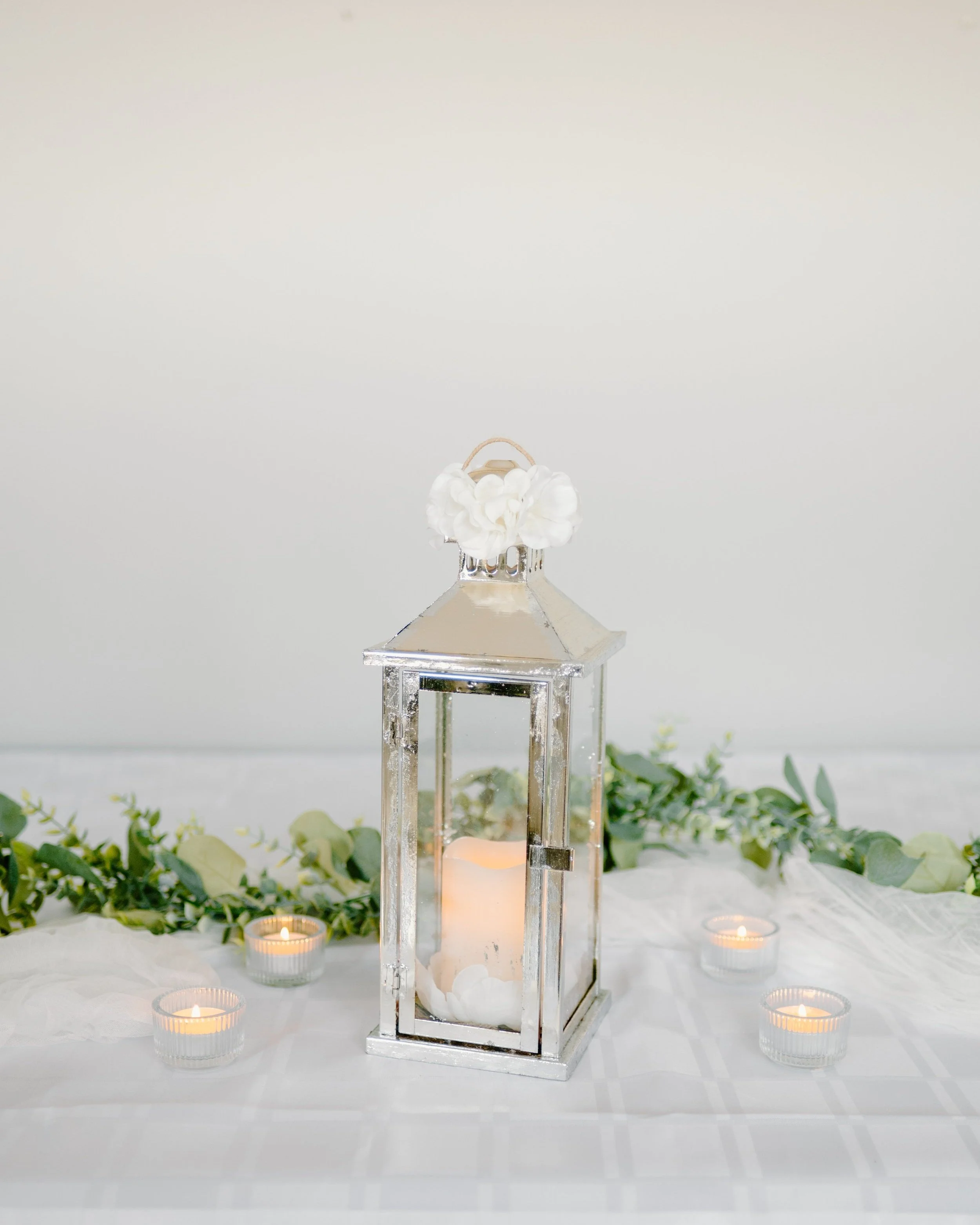 Silver with silver foil lantern. 1 candle.
13" H. 1-day rental is $20.