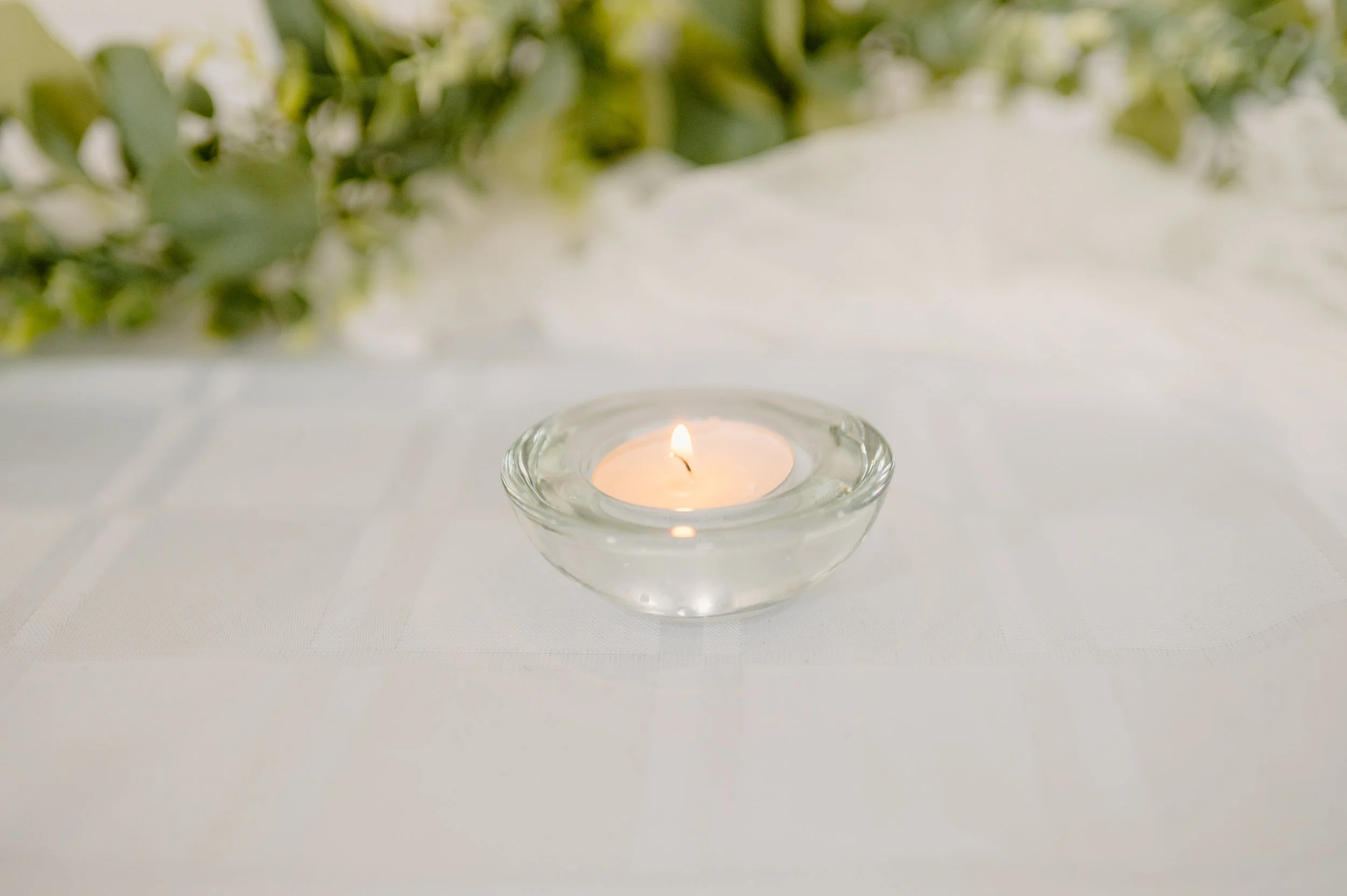 Clear tealight candle holder.  1 real tealight candle.  1-day rental is $3. 