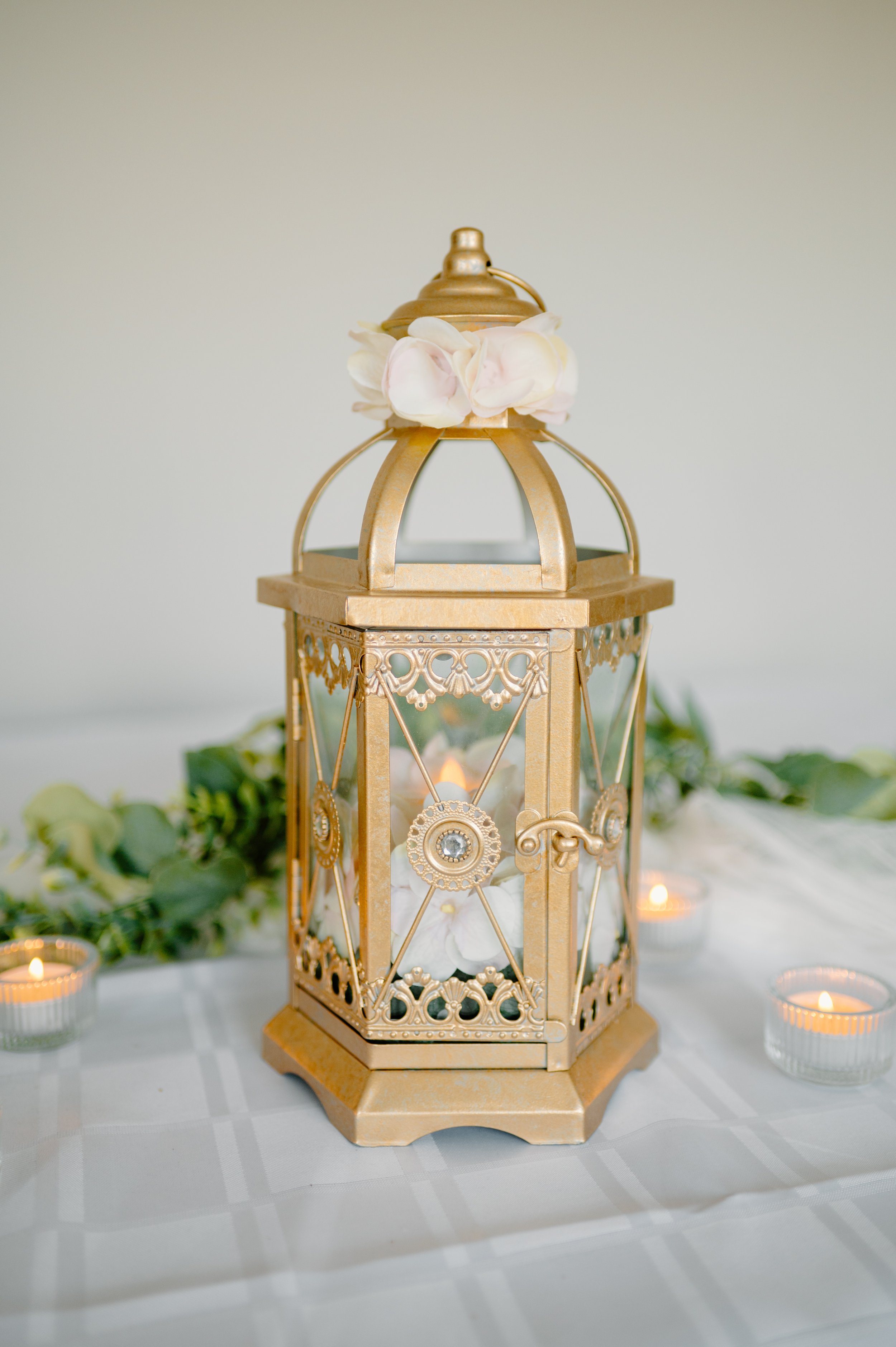 Gold metal lantern. 1 candle. 
14" H. 1-day rental is $20.