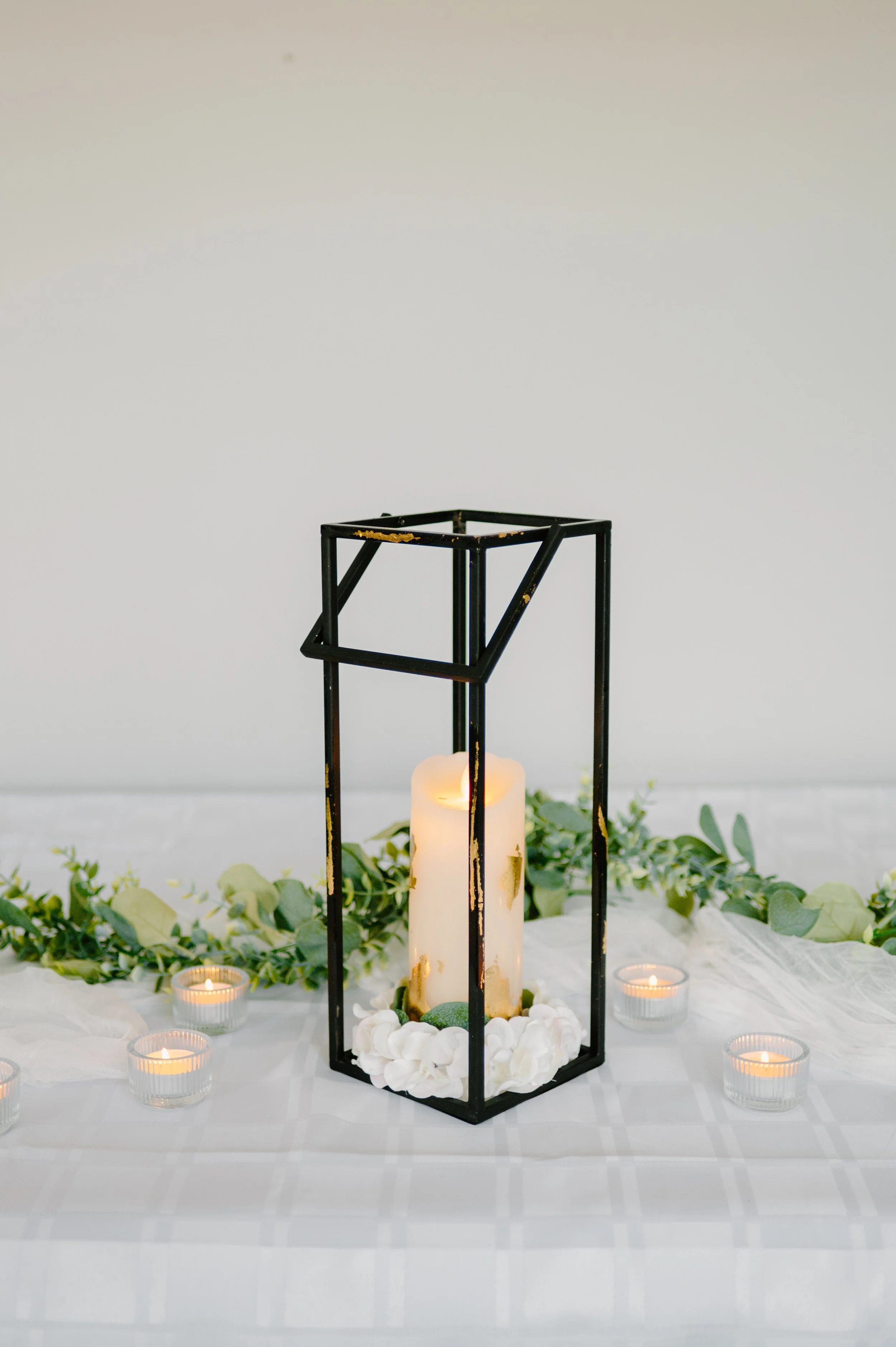 Rectangular black and gold foil lantern. 1 candle.  14" H.  1-day rental is $20.