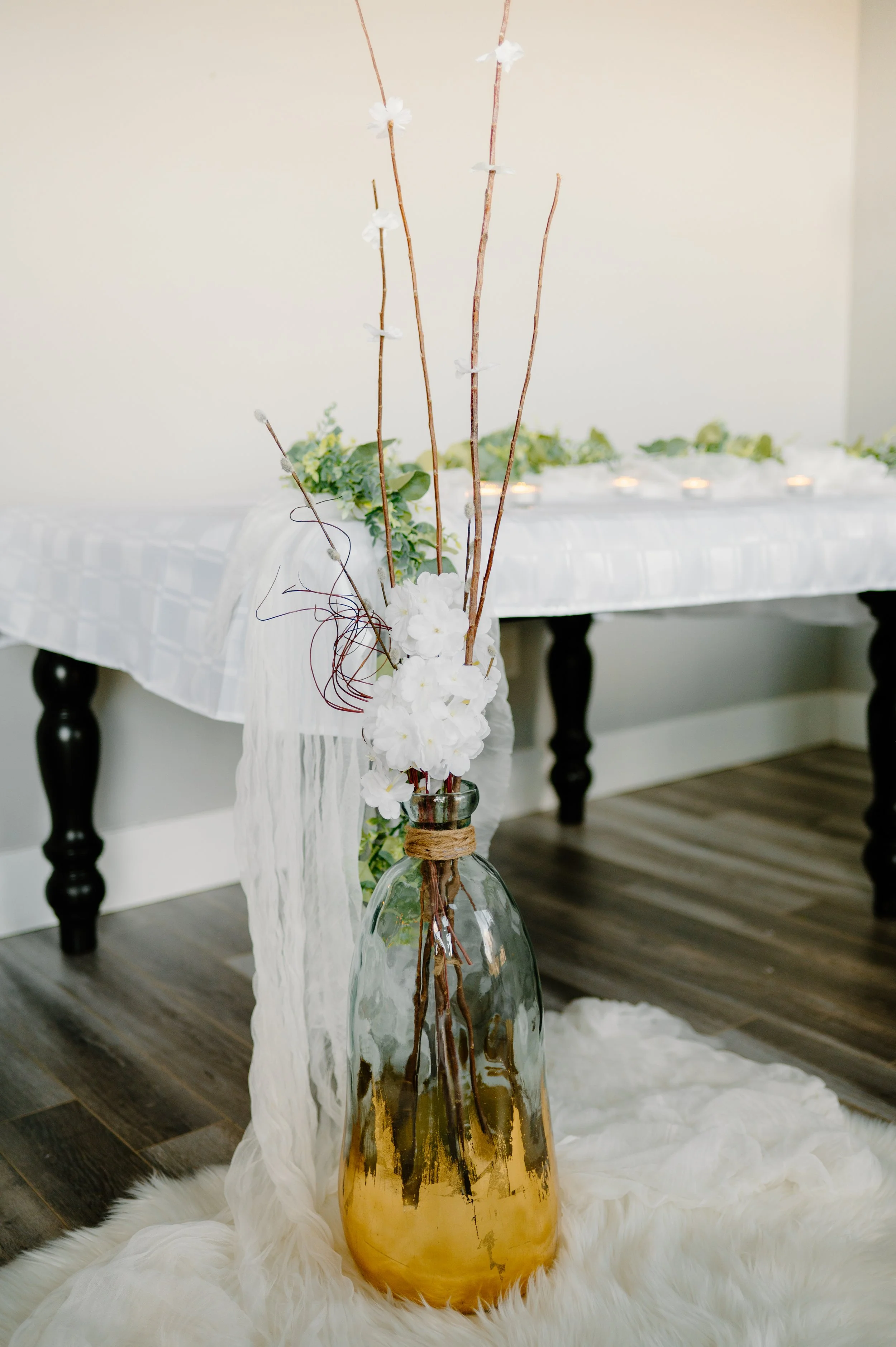 Glass vase with gold base with branches and flowers.  20" H of the vase. 
1-day rental is $40.