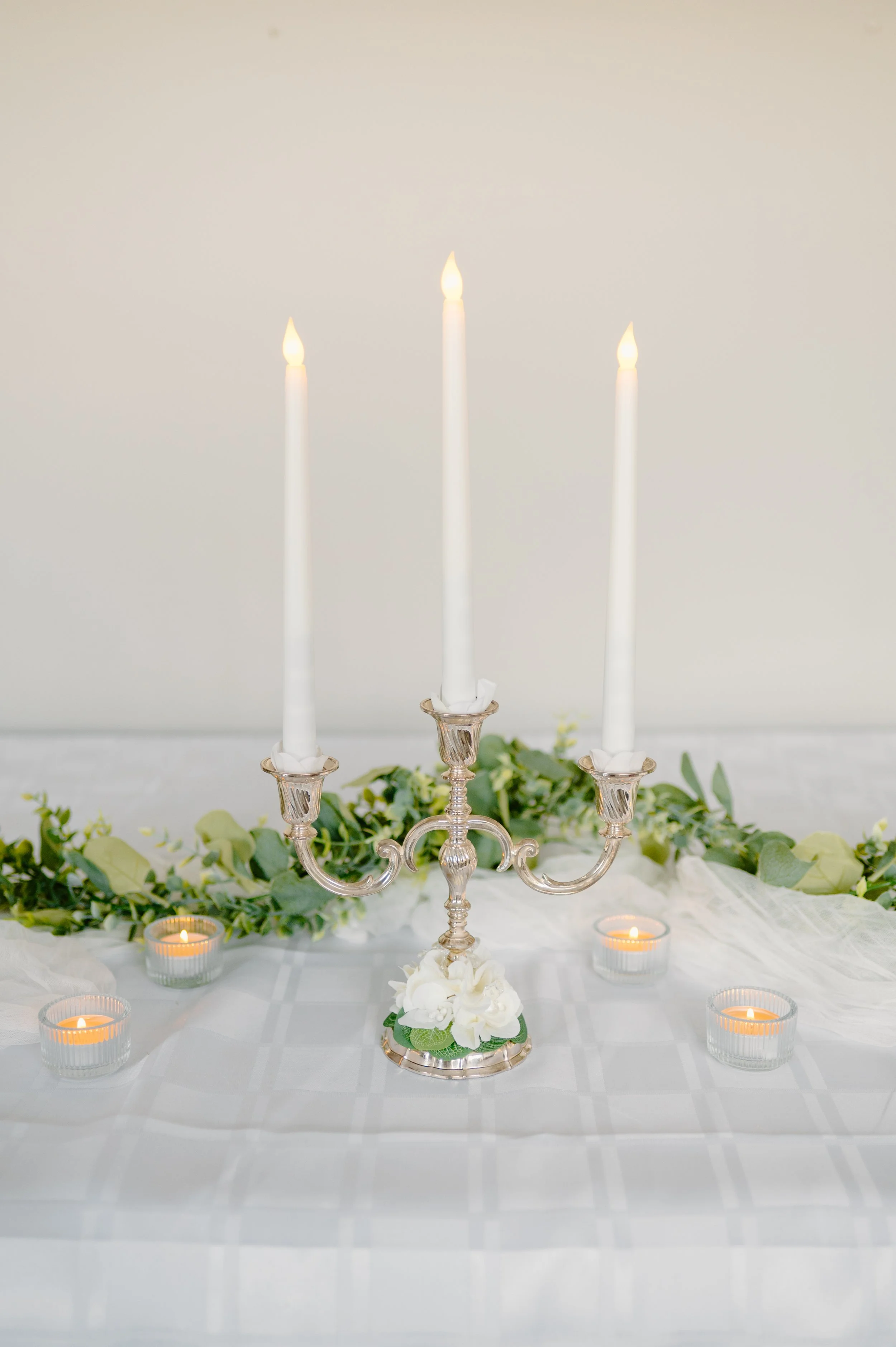 Mini silver candelabra, 3 candles. 
19" H with candles.  1-day rent is $20.
