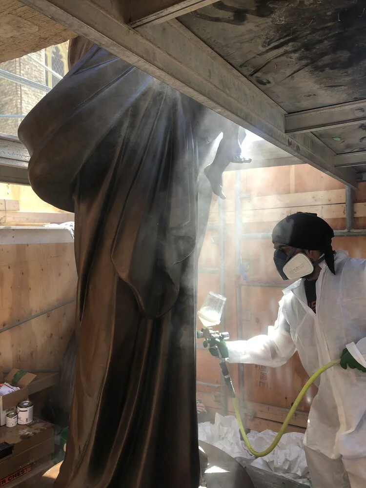 During church sculpture restoration applying final varnish layer Toronto Ontario