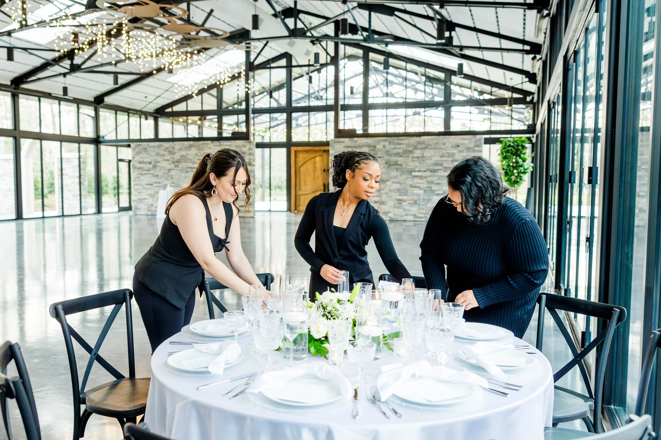 team of Richmond VA wedding planners styling a wedding reception table