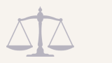 A scale of justice symbol in gray.