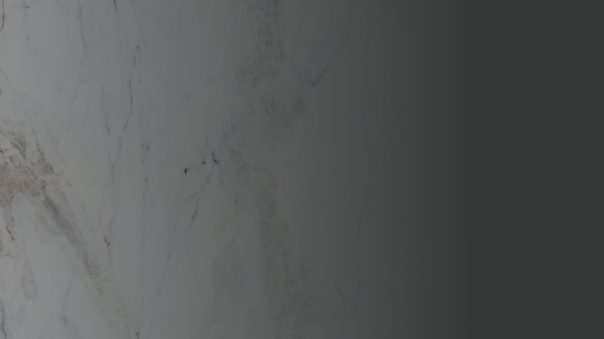 Close-up of a marble surface with white, gray, and light brown veining.