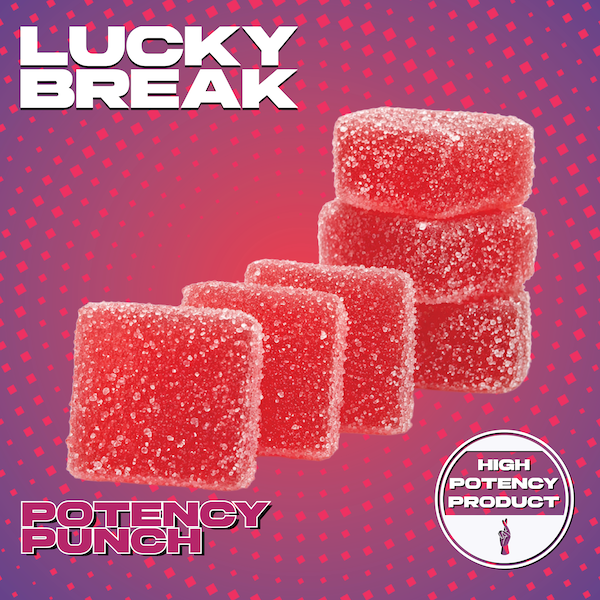 Four red gummy candies with sugar coating, stacked and placed against a pink dotted background. The image promotes Lucky Break's potent punch flavor, branded as a high potency product.