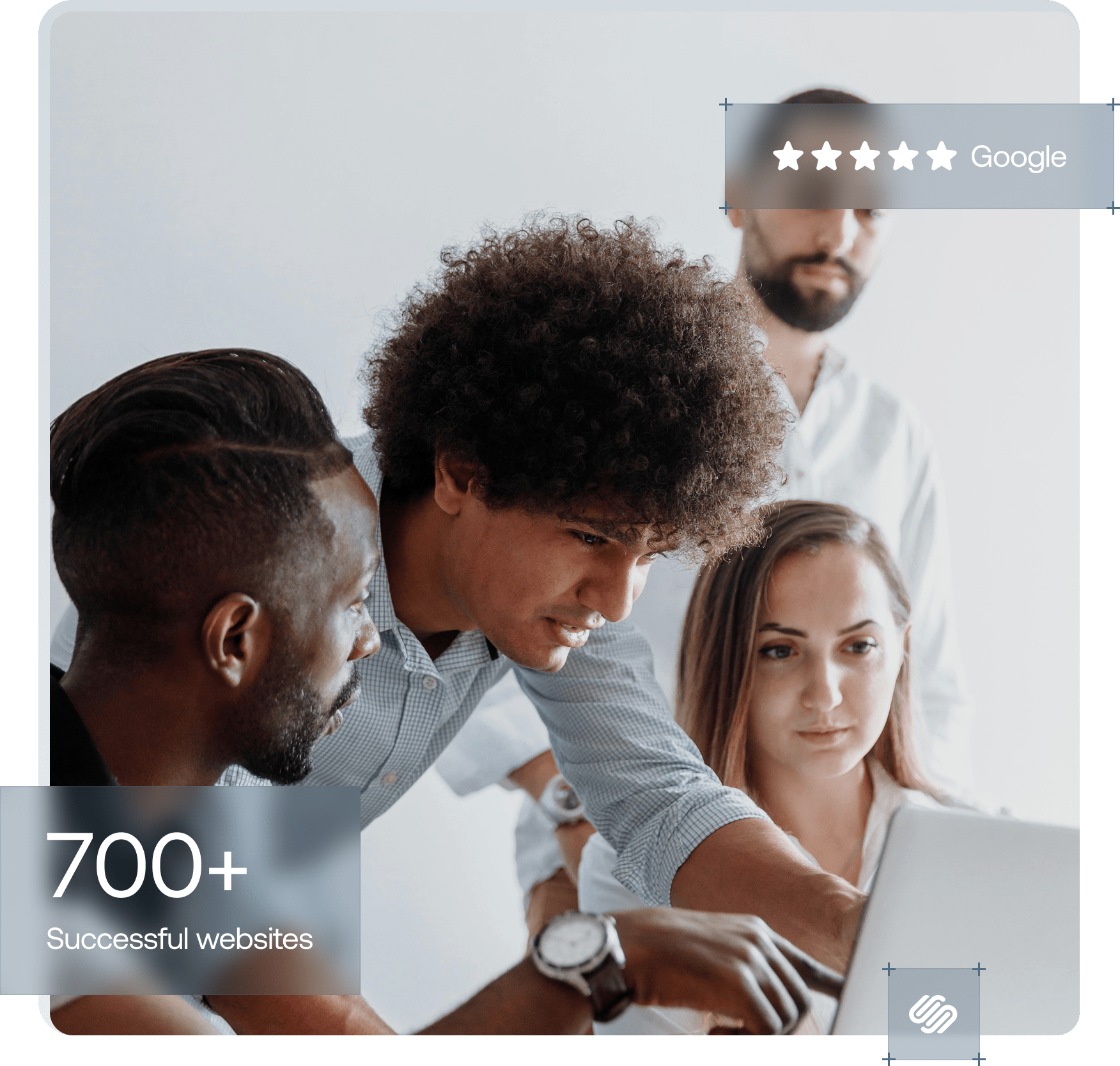 4 people focused on laptop