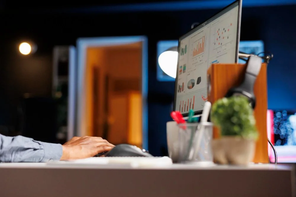 A man is engaged in typing on a computer at night, dedicated to building website.