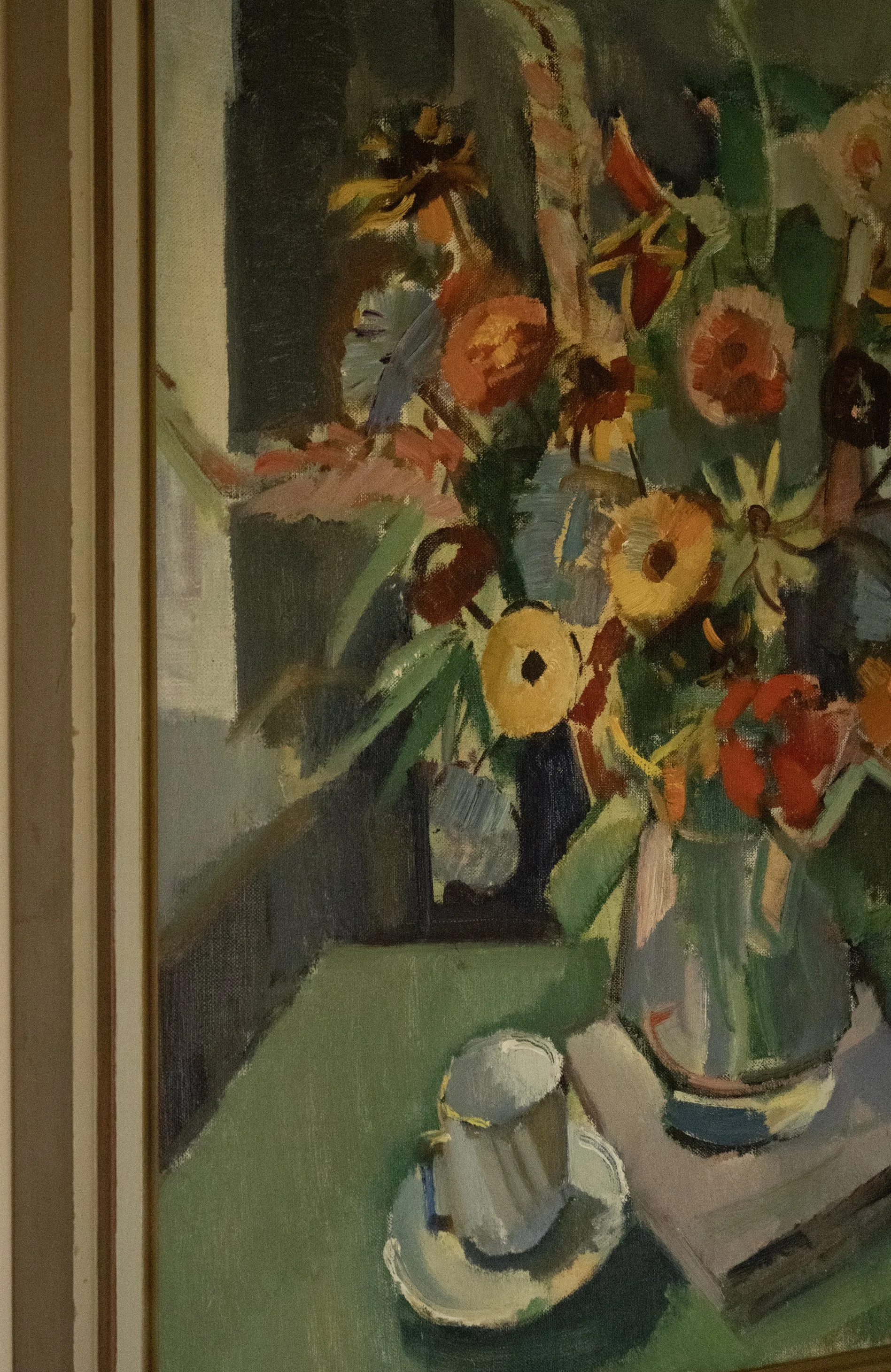 A still life oil painting of a teapot, cups, and flowers arranged on a table with a green background, featuring bold brushstrokes and vibrant colors.