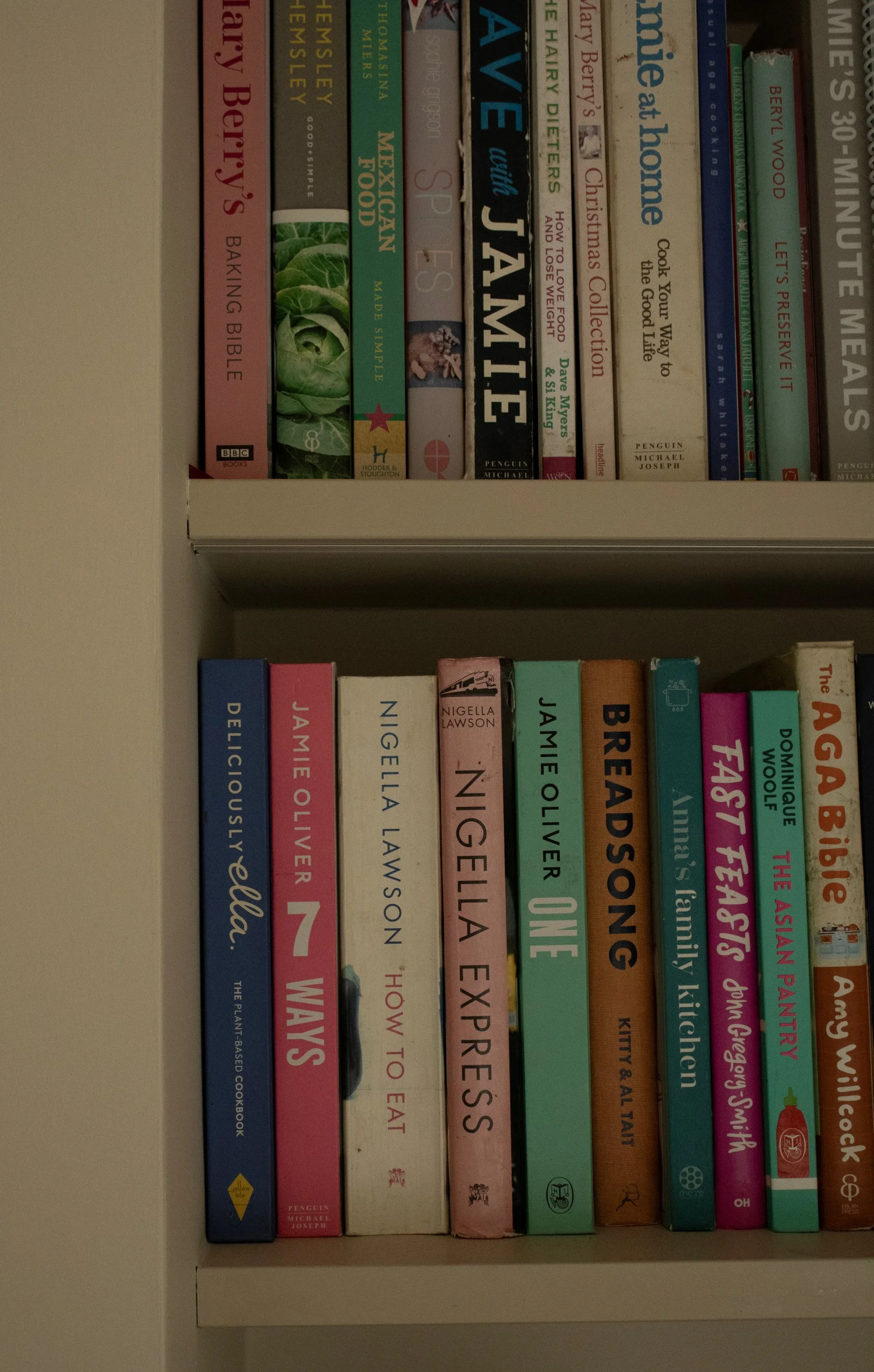 A bookshelf filled with children's books of various colors and titles.