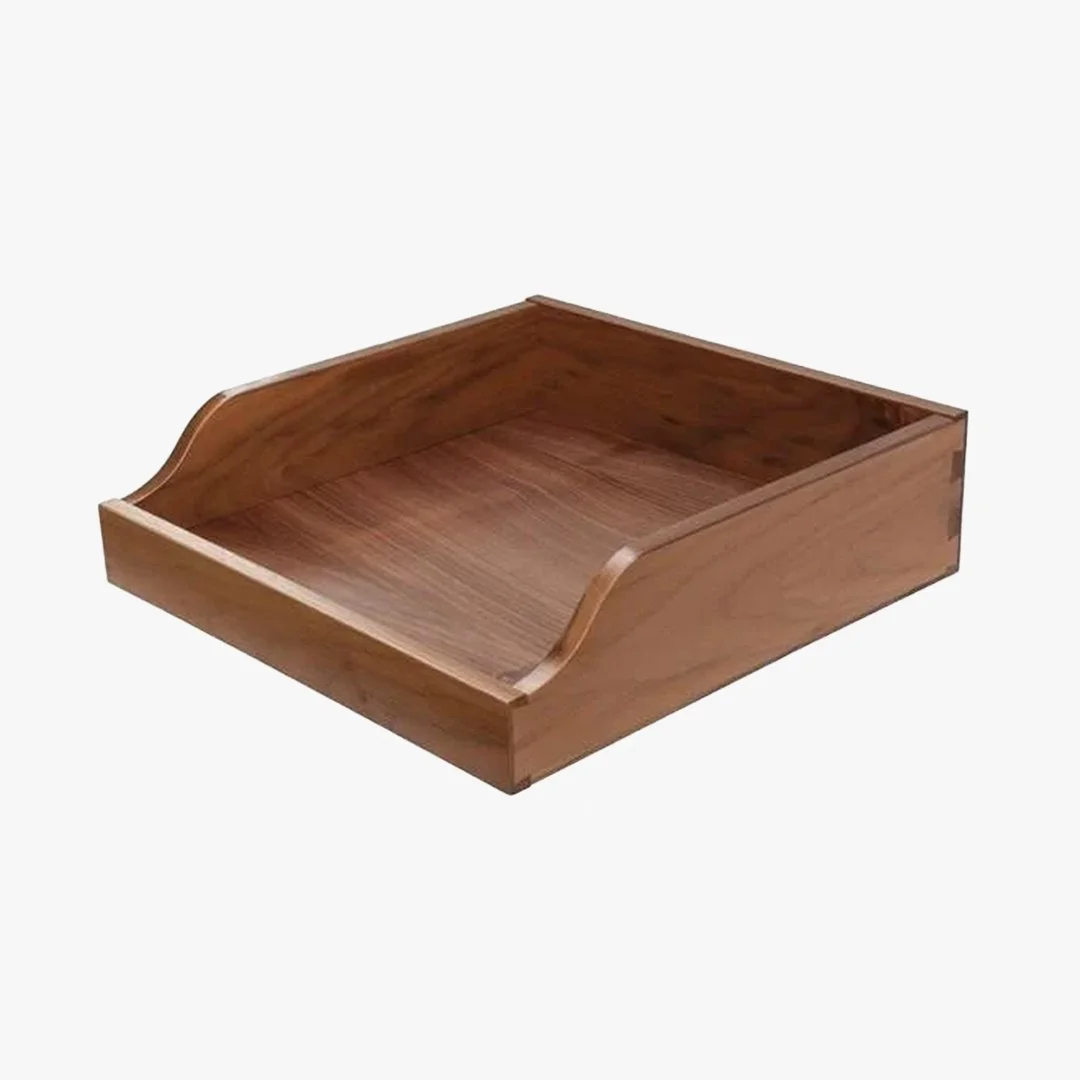 Empty wooden desktop organizer tray with curved edges on a white background.