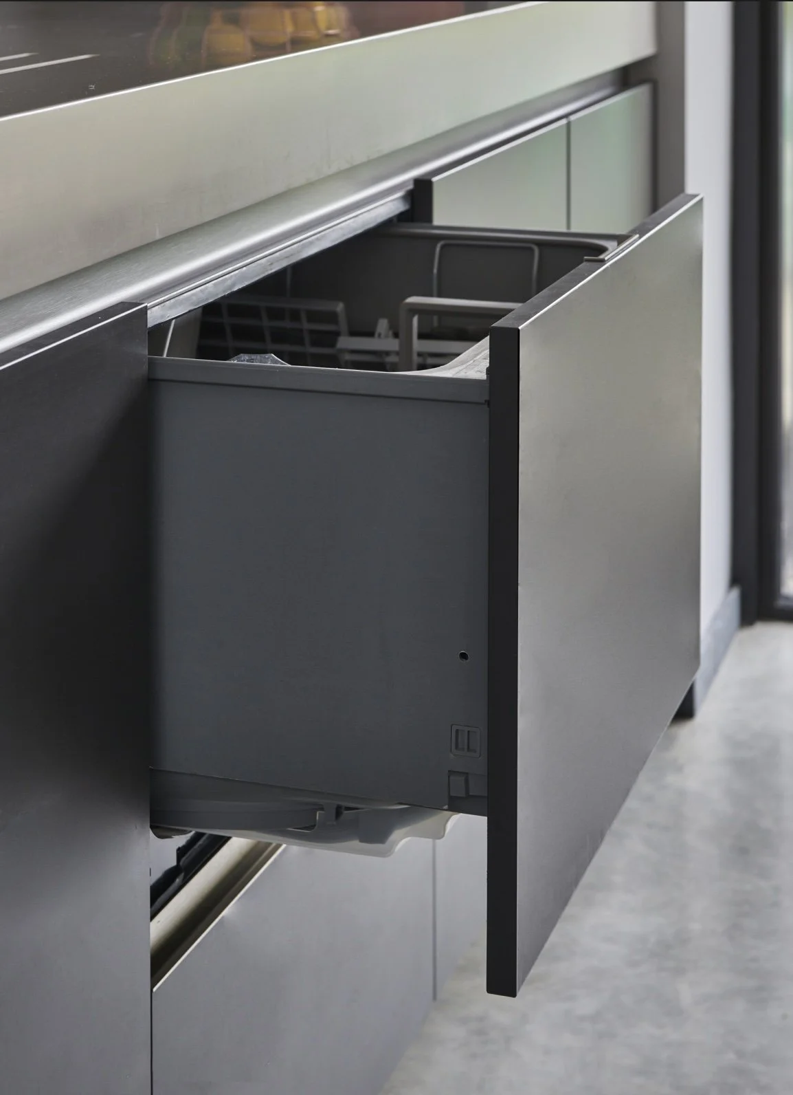 Open dishwasher with empty interior in a modern kitchen.