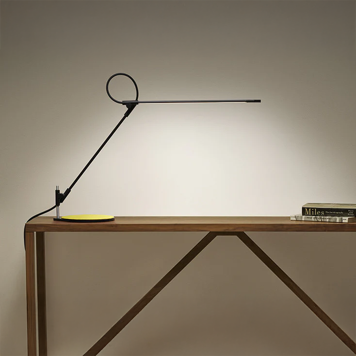 Pablo Superlight Table Lamp in black, positioned on a wooden desk