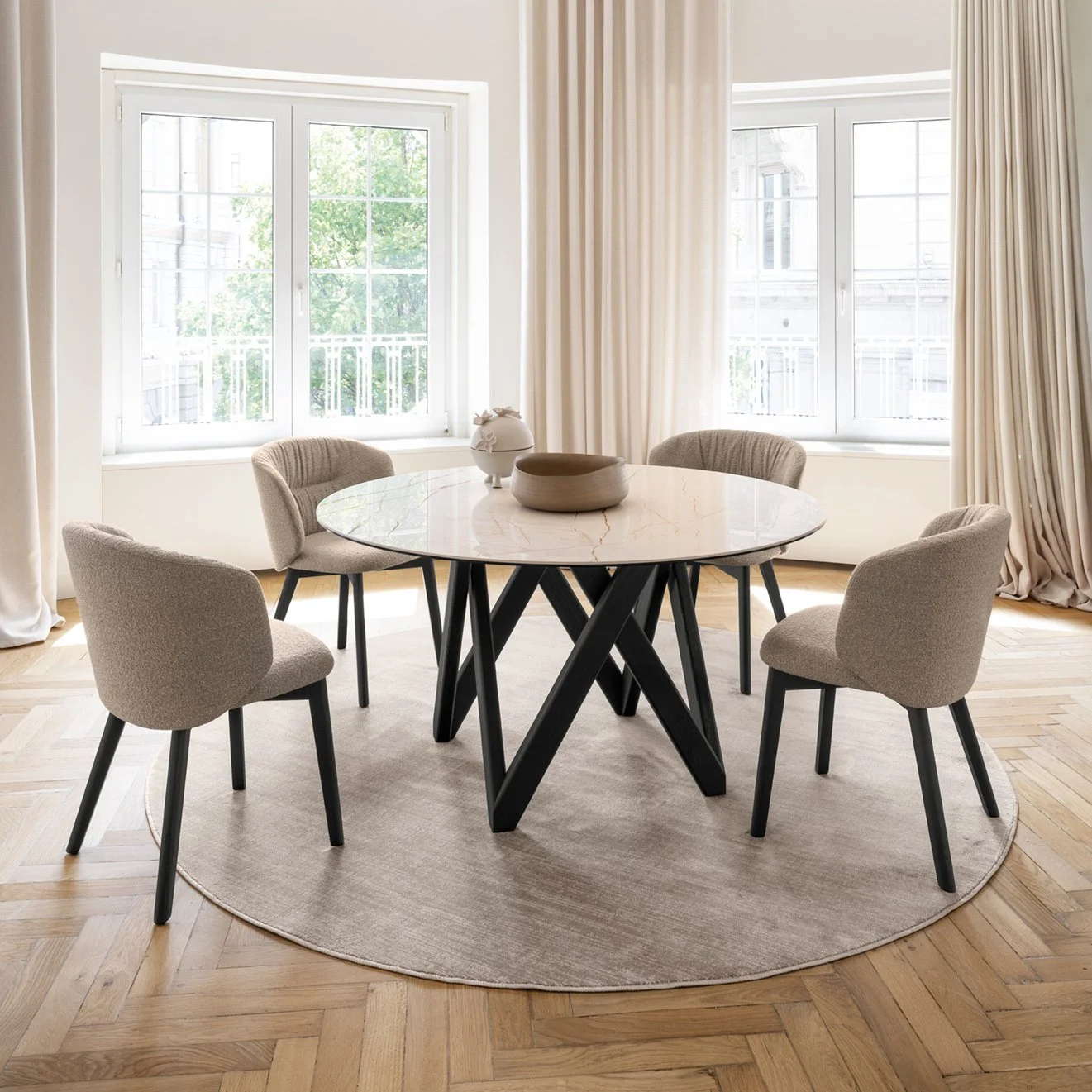 Set of Sweel Dining Chairs around a round dining table in a bright dining room