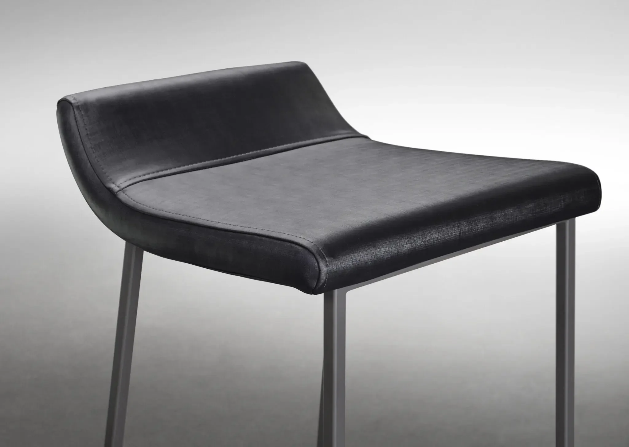 Close-up view of Zoey Stool upholstered seat in grey