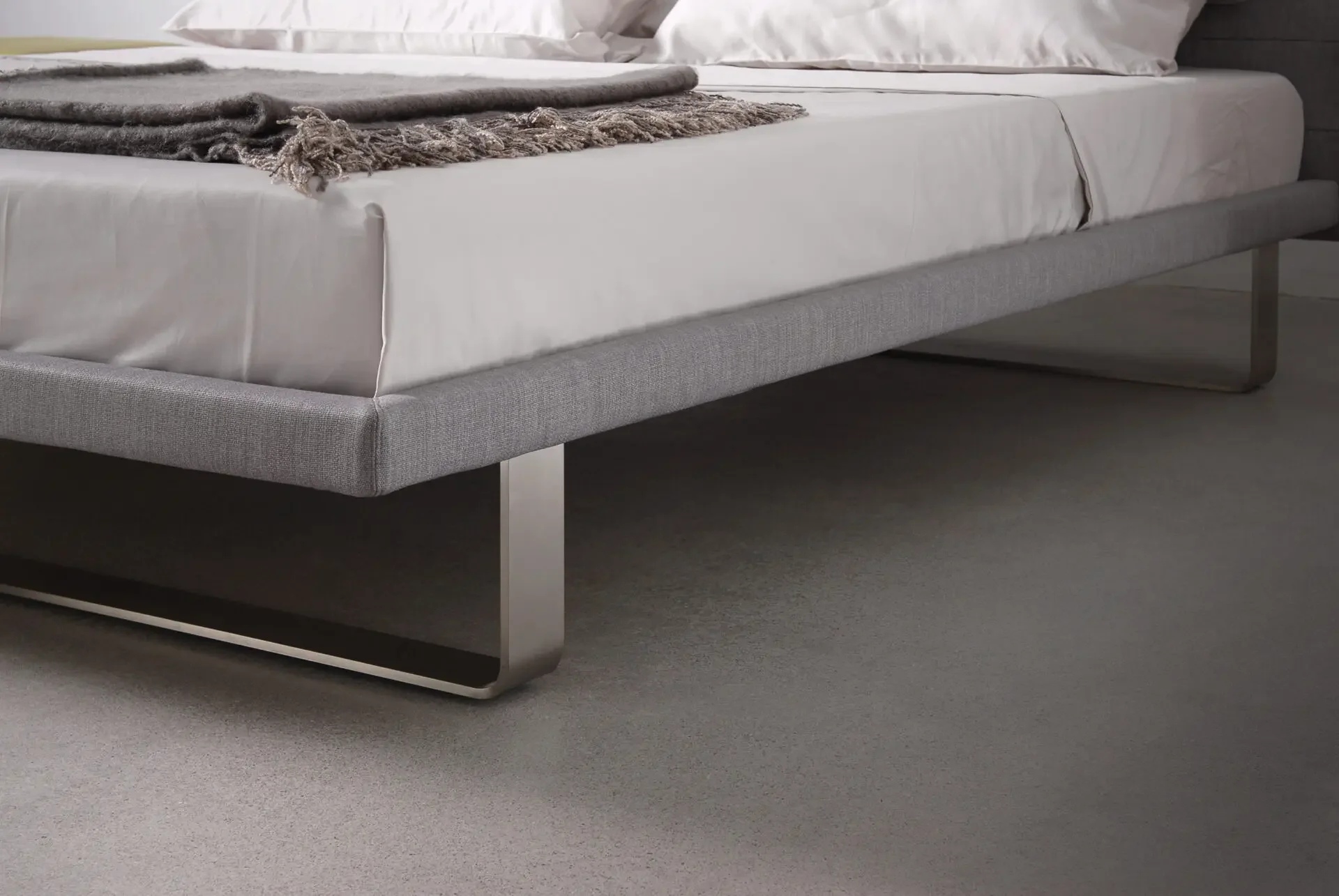 Close-up of bedding and frame on Trica Envy Bed with modern low platform base