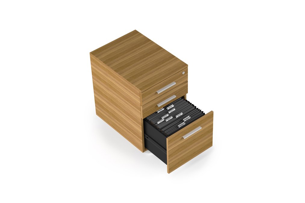 Angled view of Sequel 20 pedestal with file drawer open and hanging folders visible in natural walnut