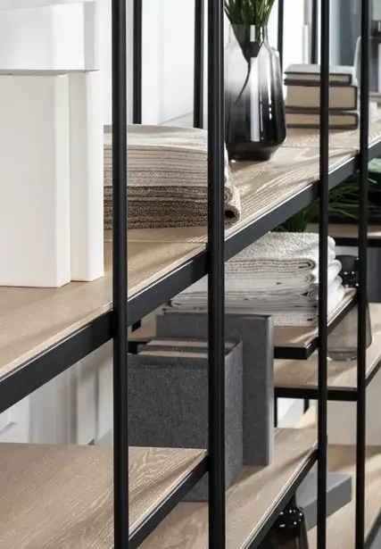 Trica Archive Shelving Unit with light wood shelves styled with décor and books