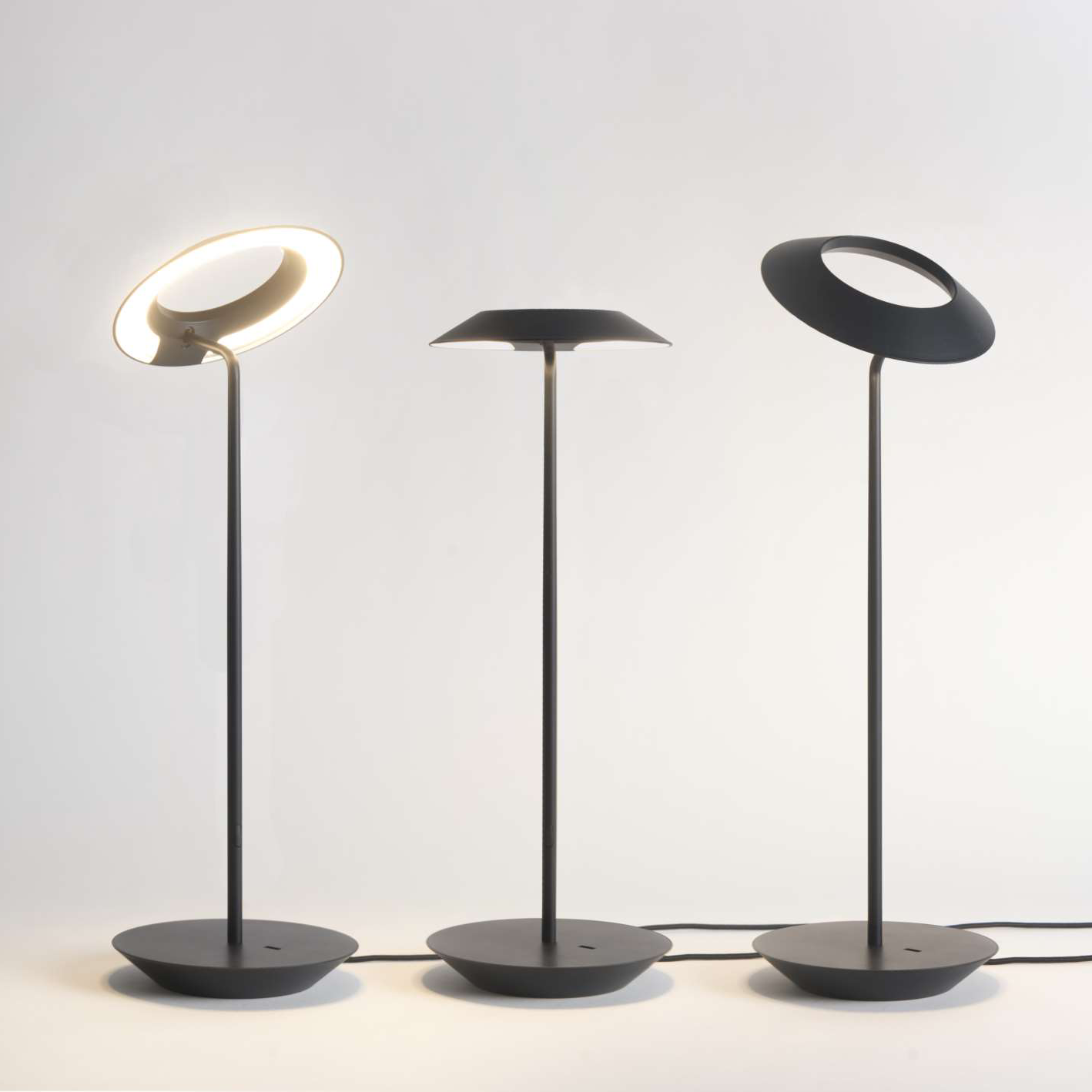 Group of three Koncept Royyo Desk Lamps in black, white, and silver