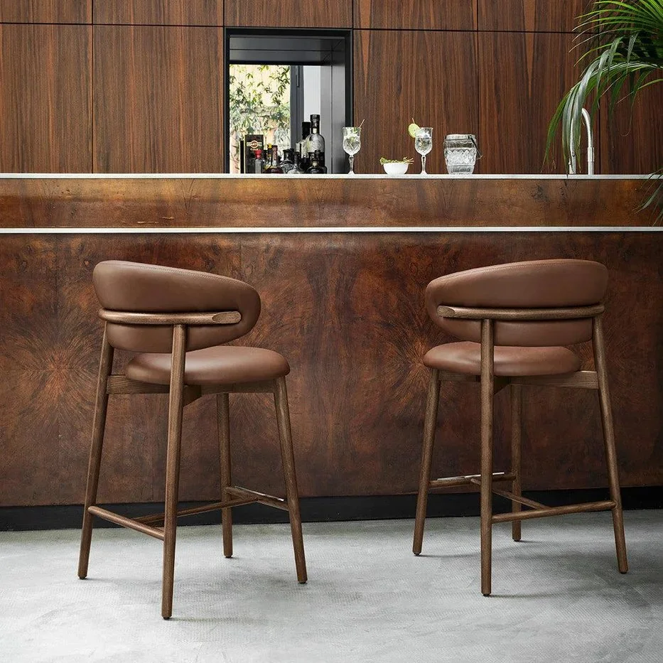 Pair of Calligaris Oleandro Stools in brown leather set at a wooden home bar