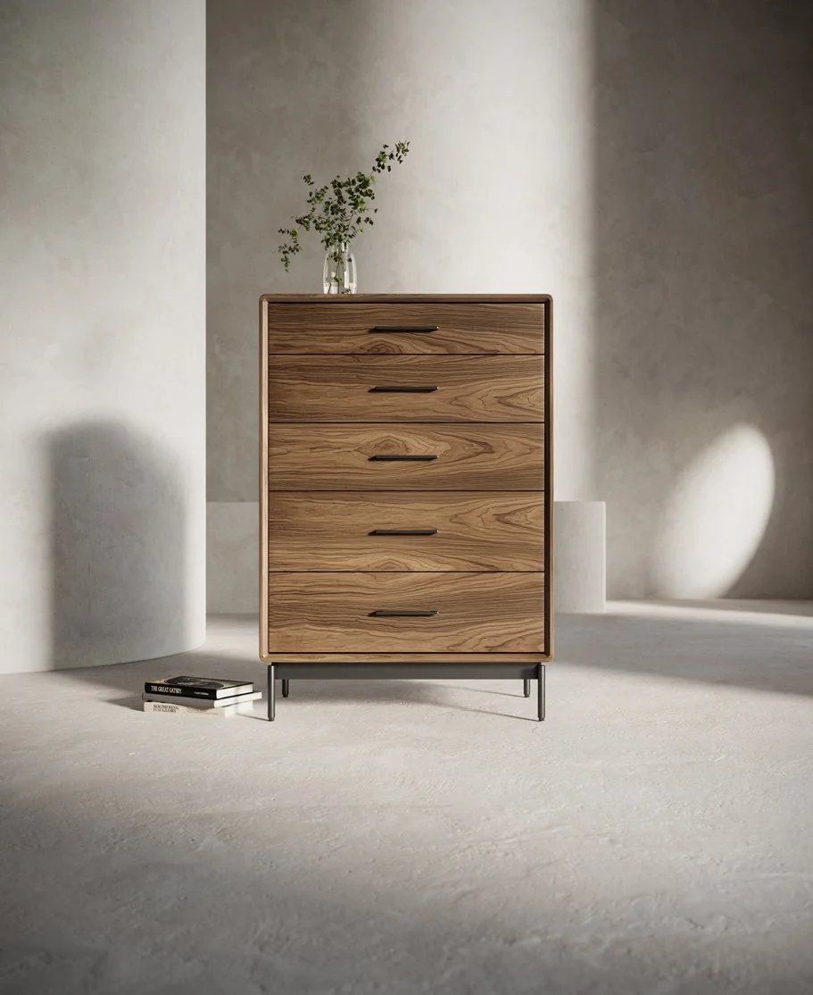 Front lifestyle image of LINQ chest with tall shadowed background and decor objects on top