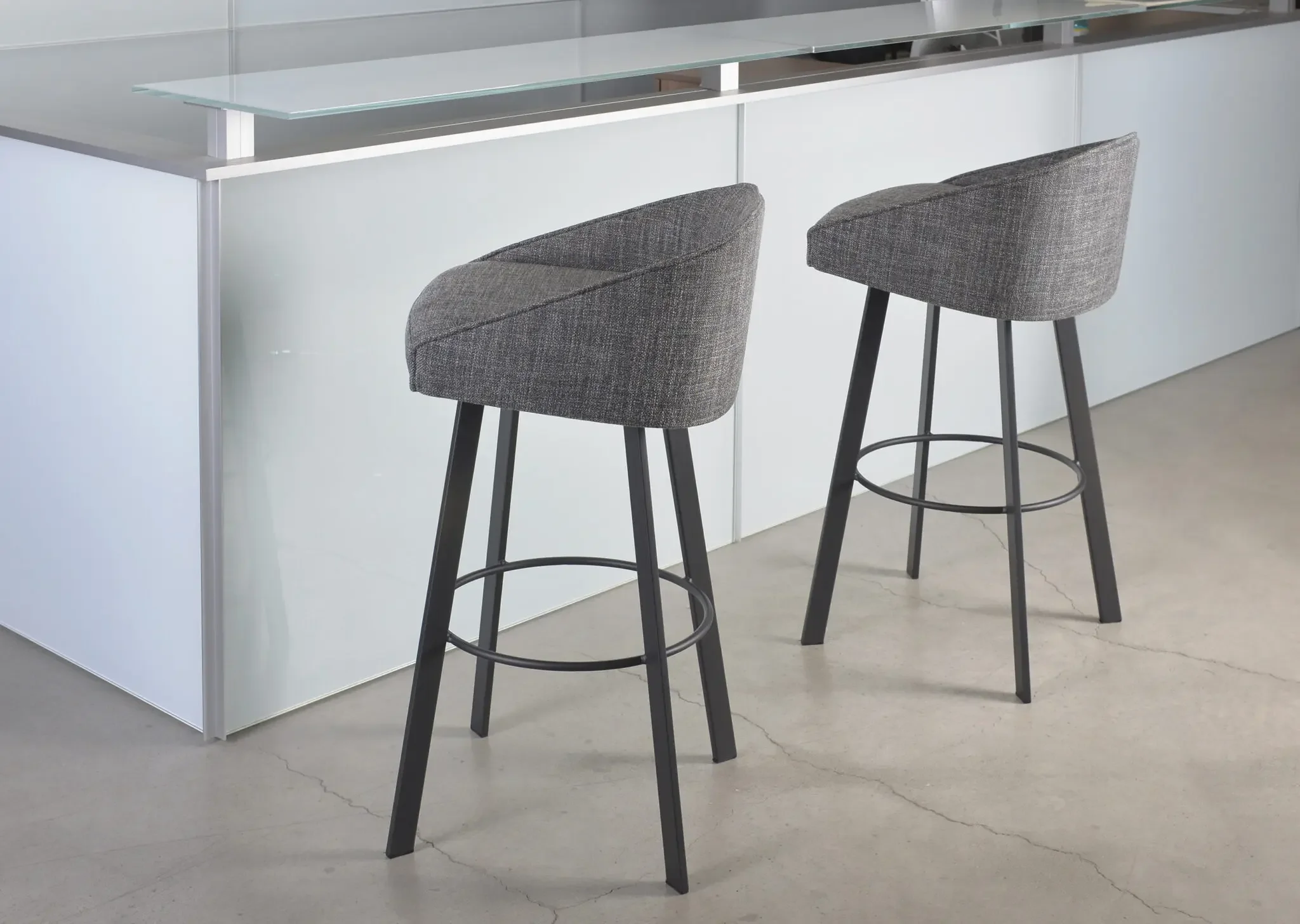 Pair of Trica Liv Counter Stools in grey upholstery beside modern kitchen island