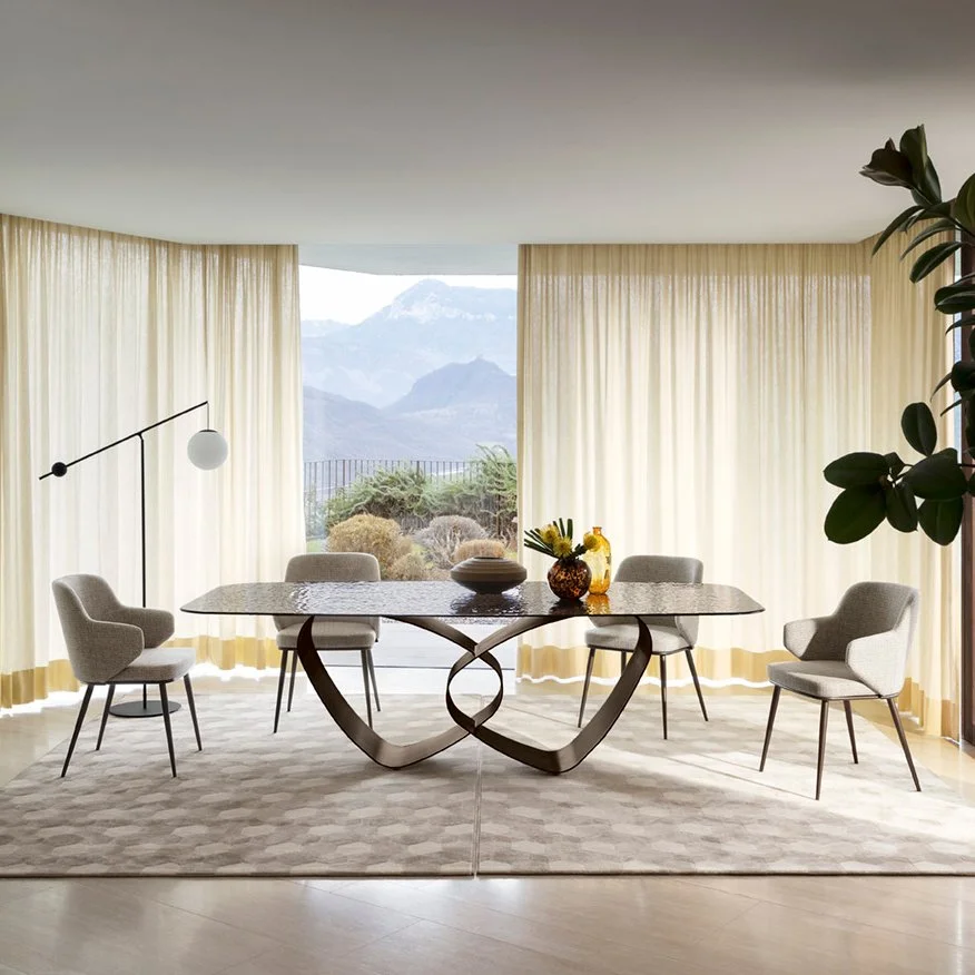 Breeze Table in a bright modern dining room with mountain views and neutral chairs
