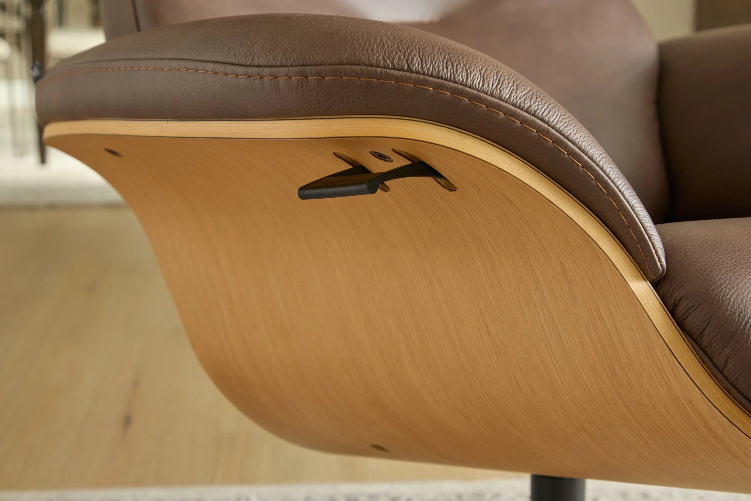 Close-up of Fjords Falcon Chair wood shell and leather upholstery