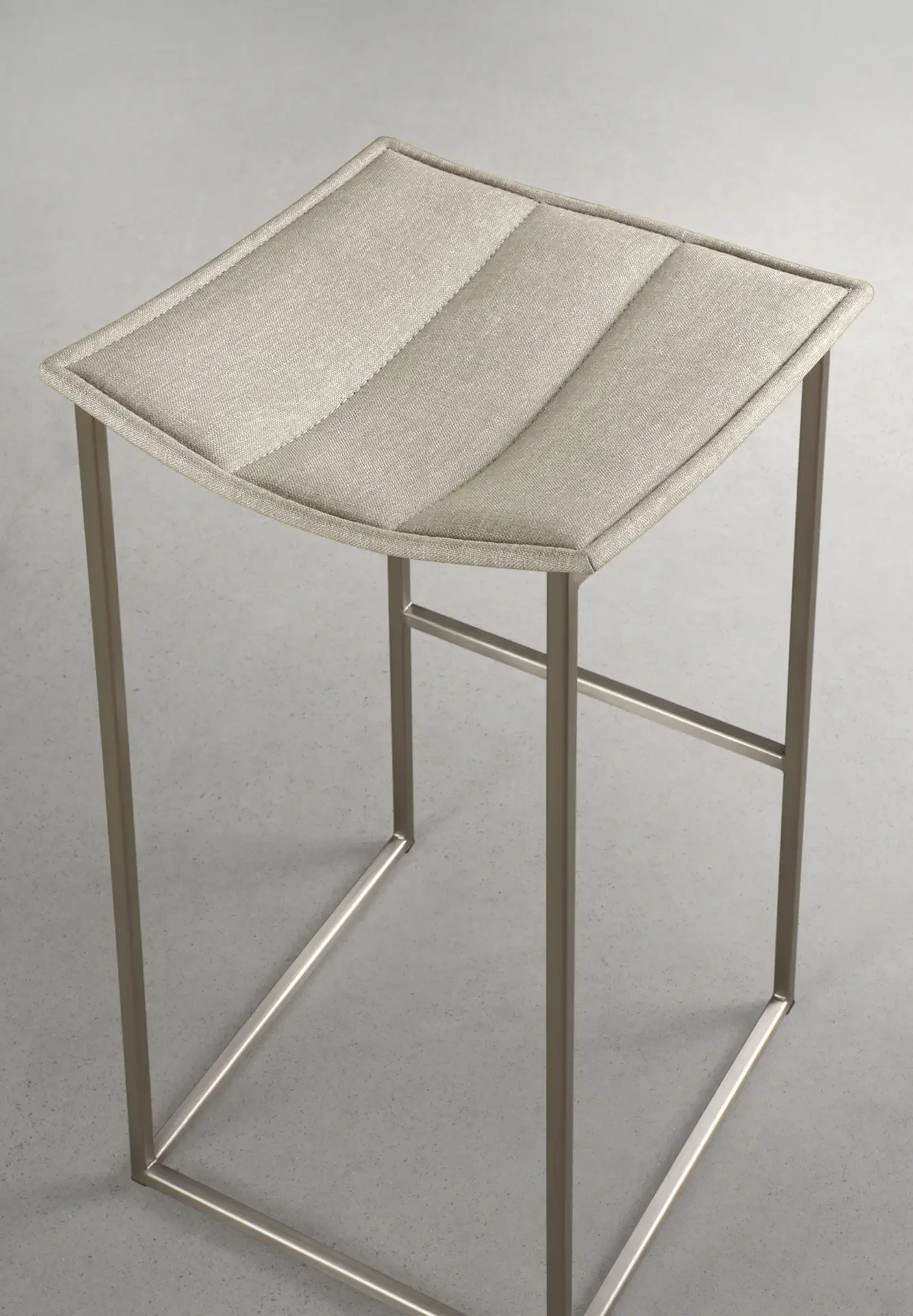 Trica Bocca Counter Stool with light beige upholstered seat and stainless steel frame, angled view