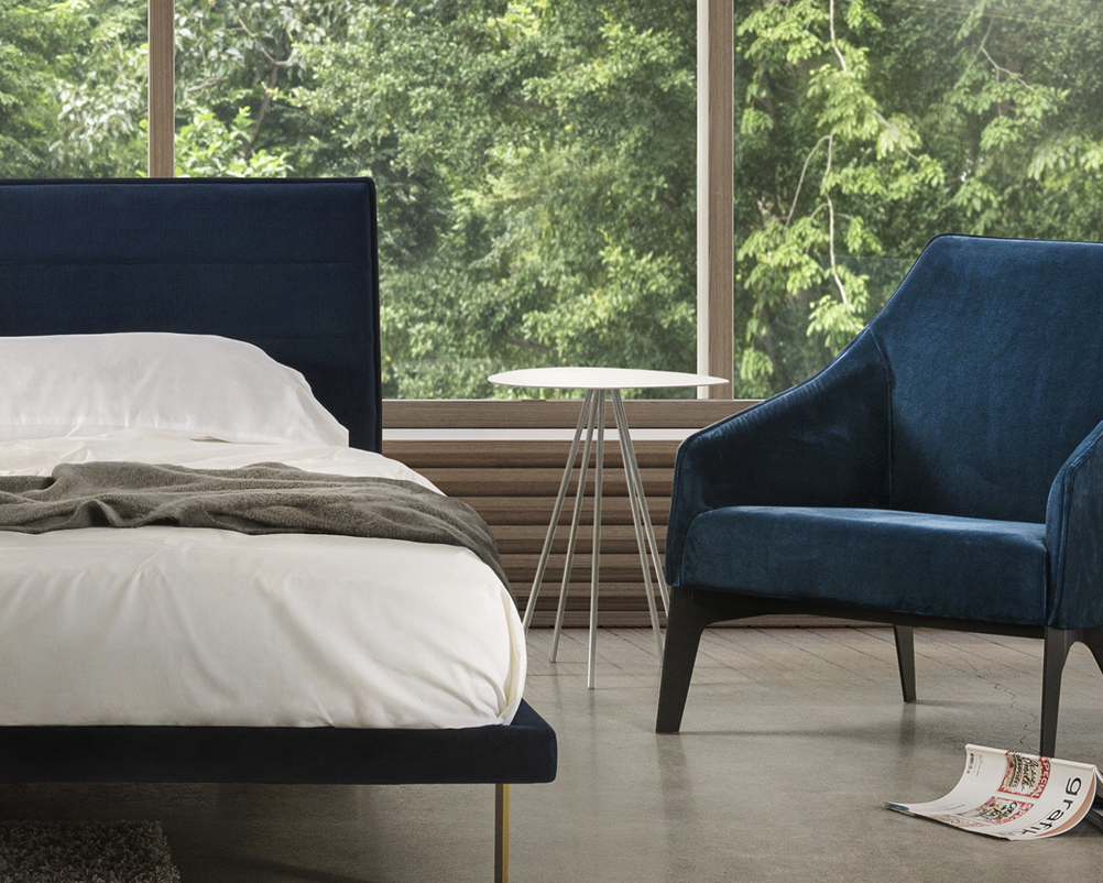 Trica Cloud-5 Accent Table placed between two blue lounge chairs in modern bedroom