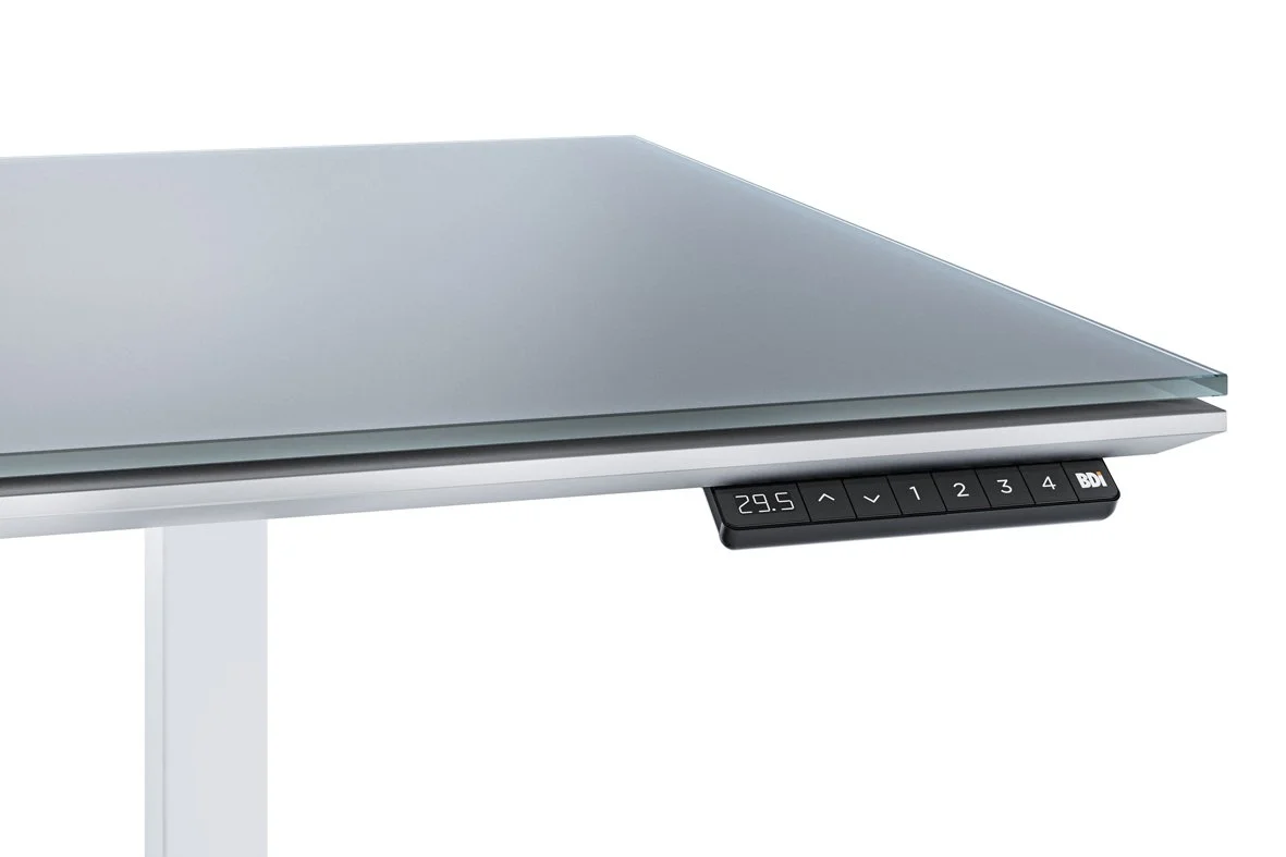 Close-up of Centro Sit + Stand Desk corner showing satin-etched glass surface and digital control panel