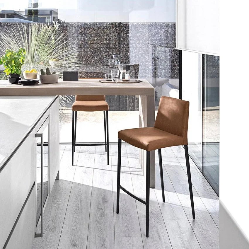 Pair of Calligaris Aida Stools in a modern kitchen with white countertop and city view