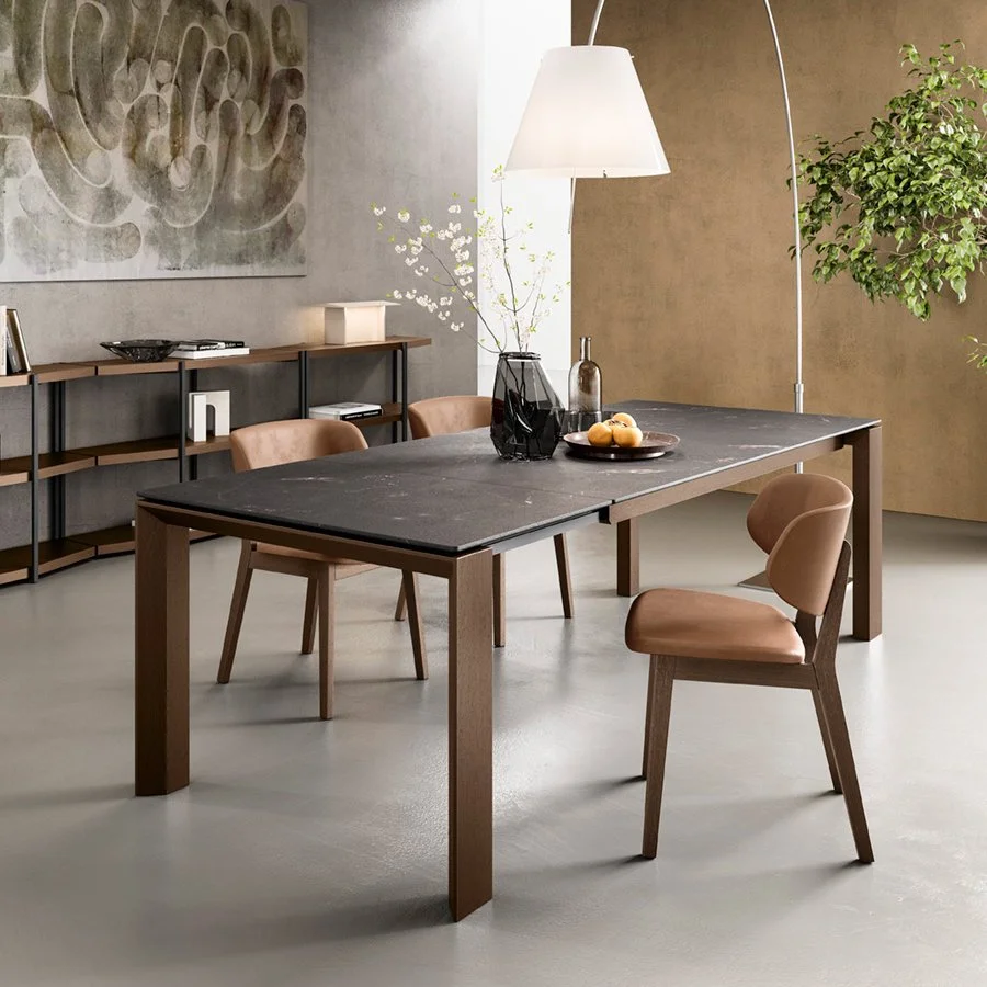 Omnia Table in dark stone finish with upholstered dining chairs in a cozy dining space