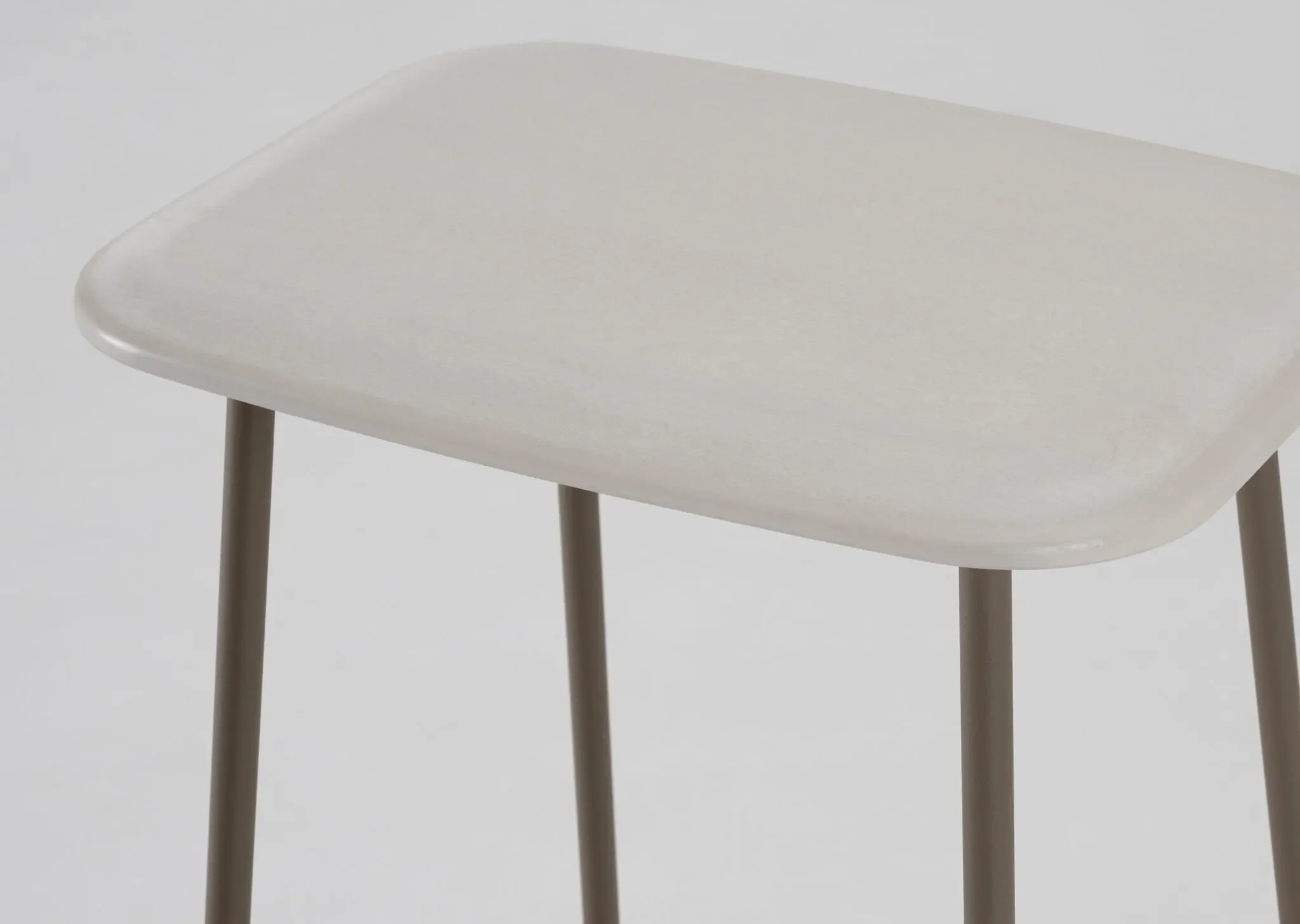 Close-up of Palmo Stool seat showcasing smooth wood finish
