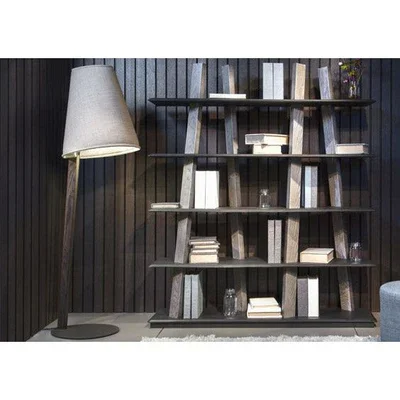Trica Chapo Lamp with dark shade placed beside modern black bookcase in styled interior