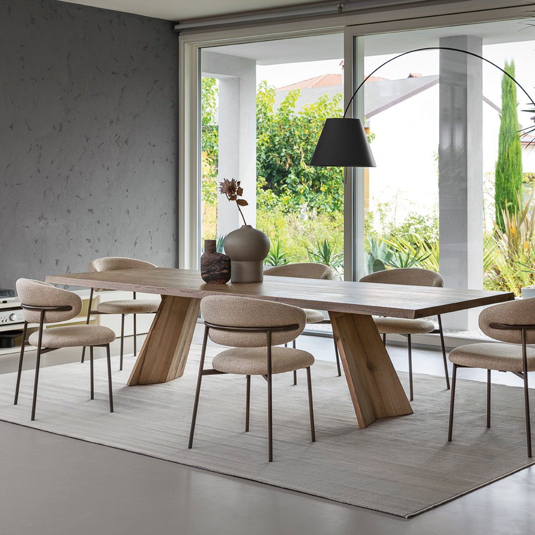 Set of Calligaris Oleandro Dining Chairs around a modern wooden dining table in a bright open room