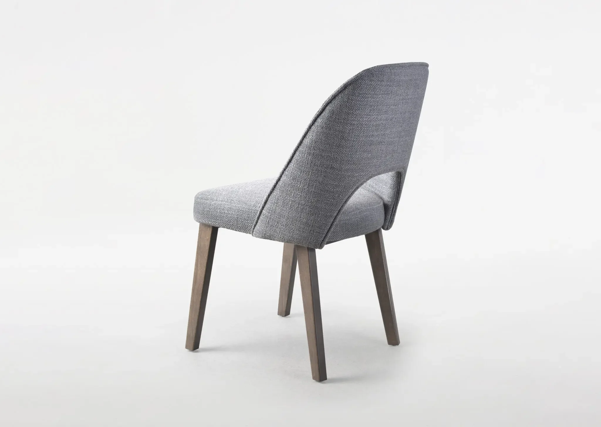 Side view of Trica Mia Dining Chair highlighting angled legs and contoured seat