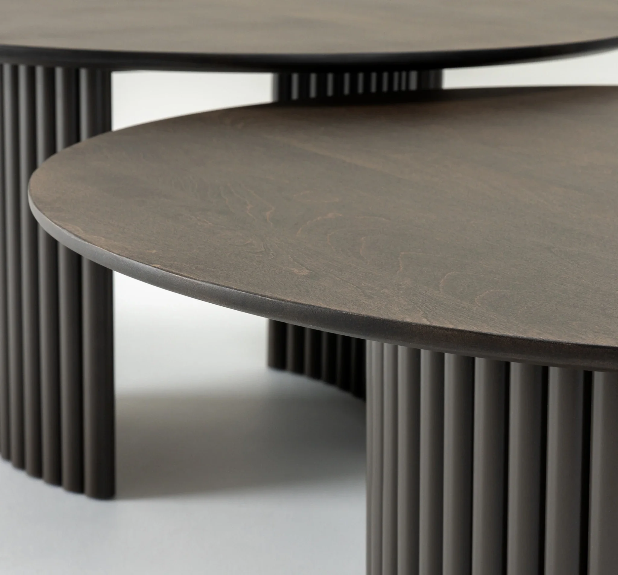 Close-up of Trica Cove Cocktail Table wood top and fluted base detail