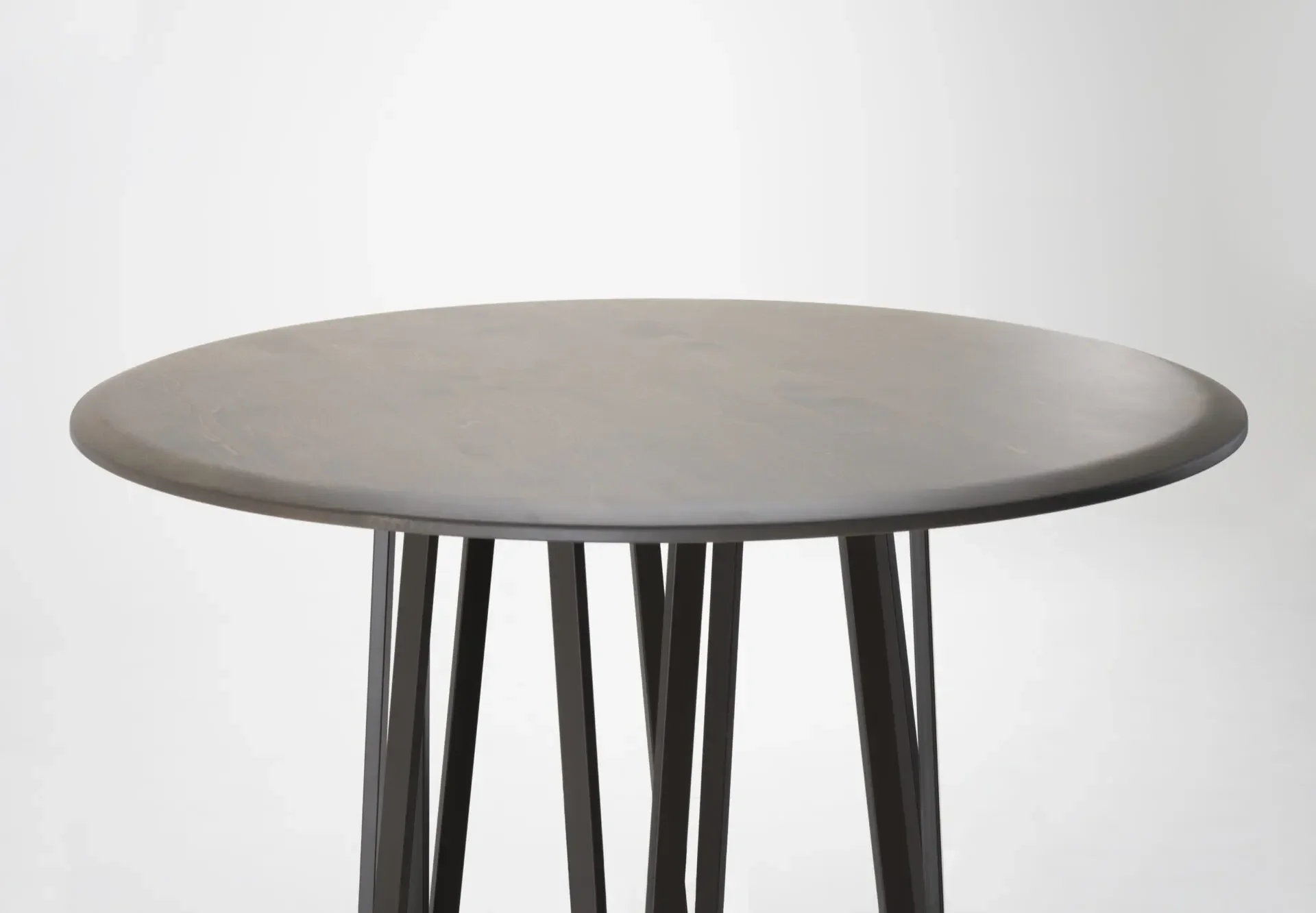 Angled detail of the Opal table highlighting the tabletop finish and sturdy legs
